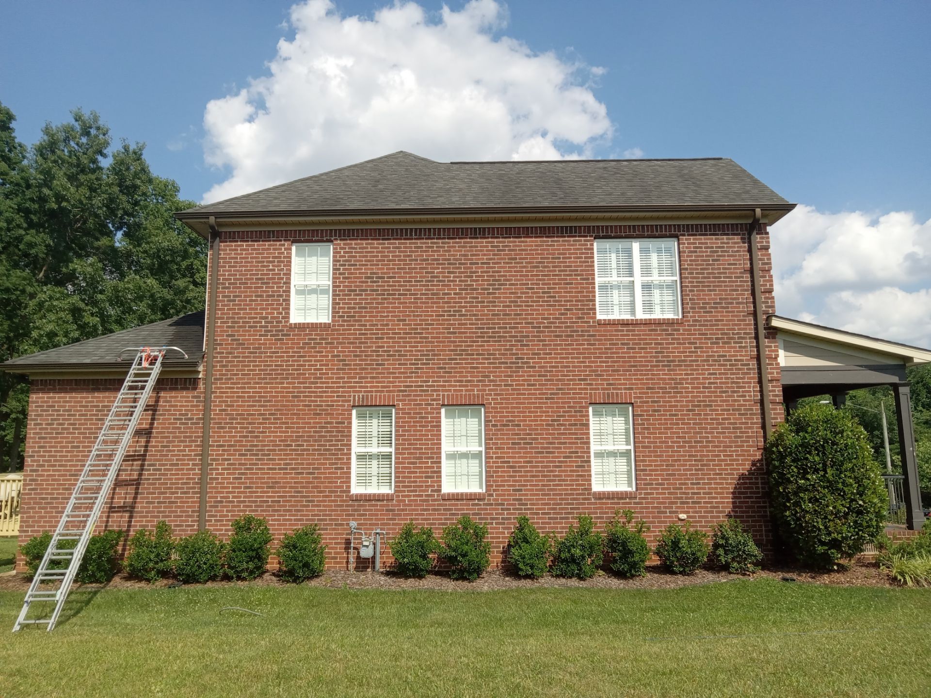 pressure washing exterior brick walls removing dirt buildup and stains restoring surface appearance