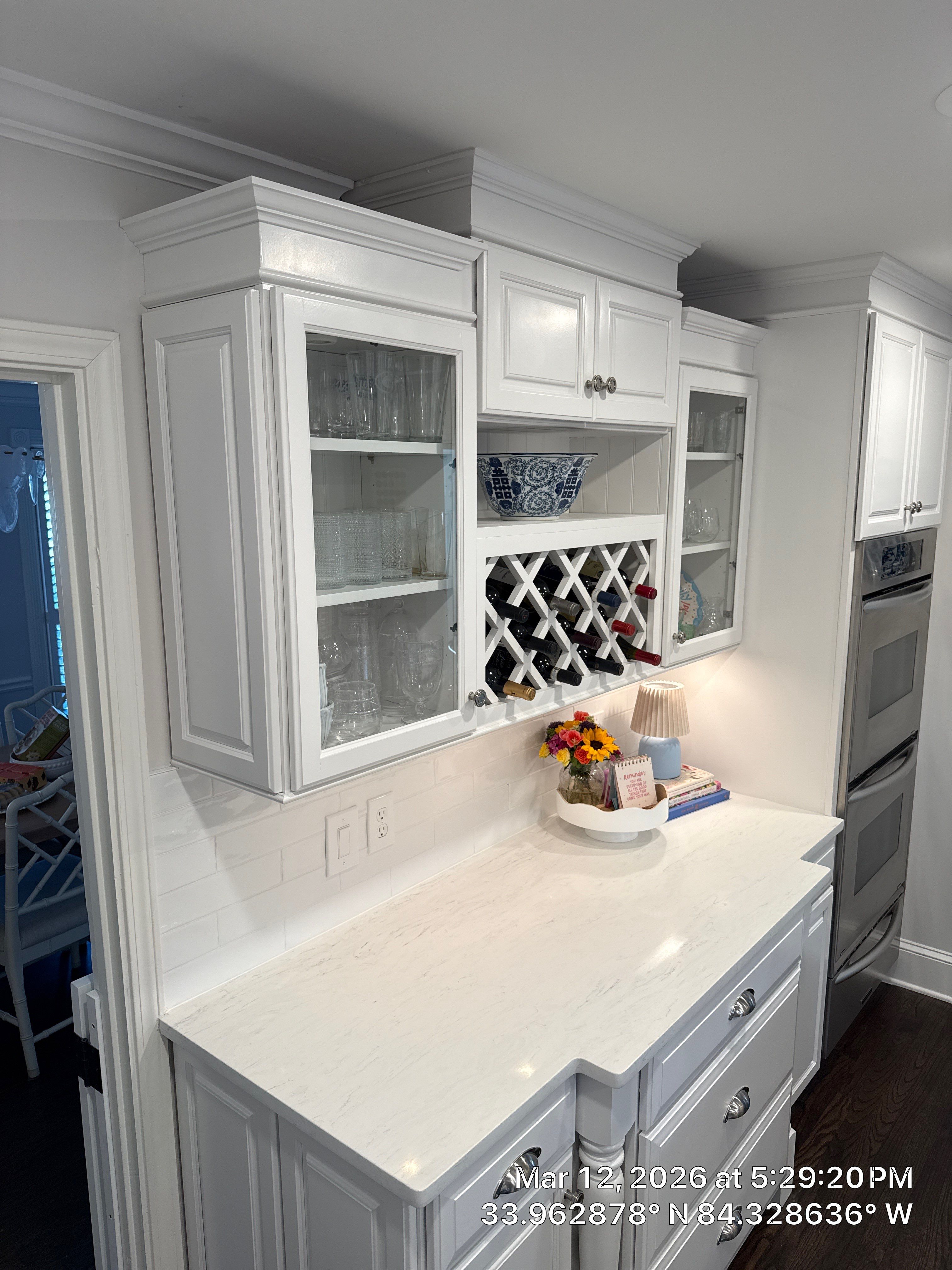 Kitchen Remodel in Dunwoody Featuring White Cabinetry and Blue Island by Heart & Home Kitchen & Bath Remodeling LLC