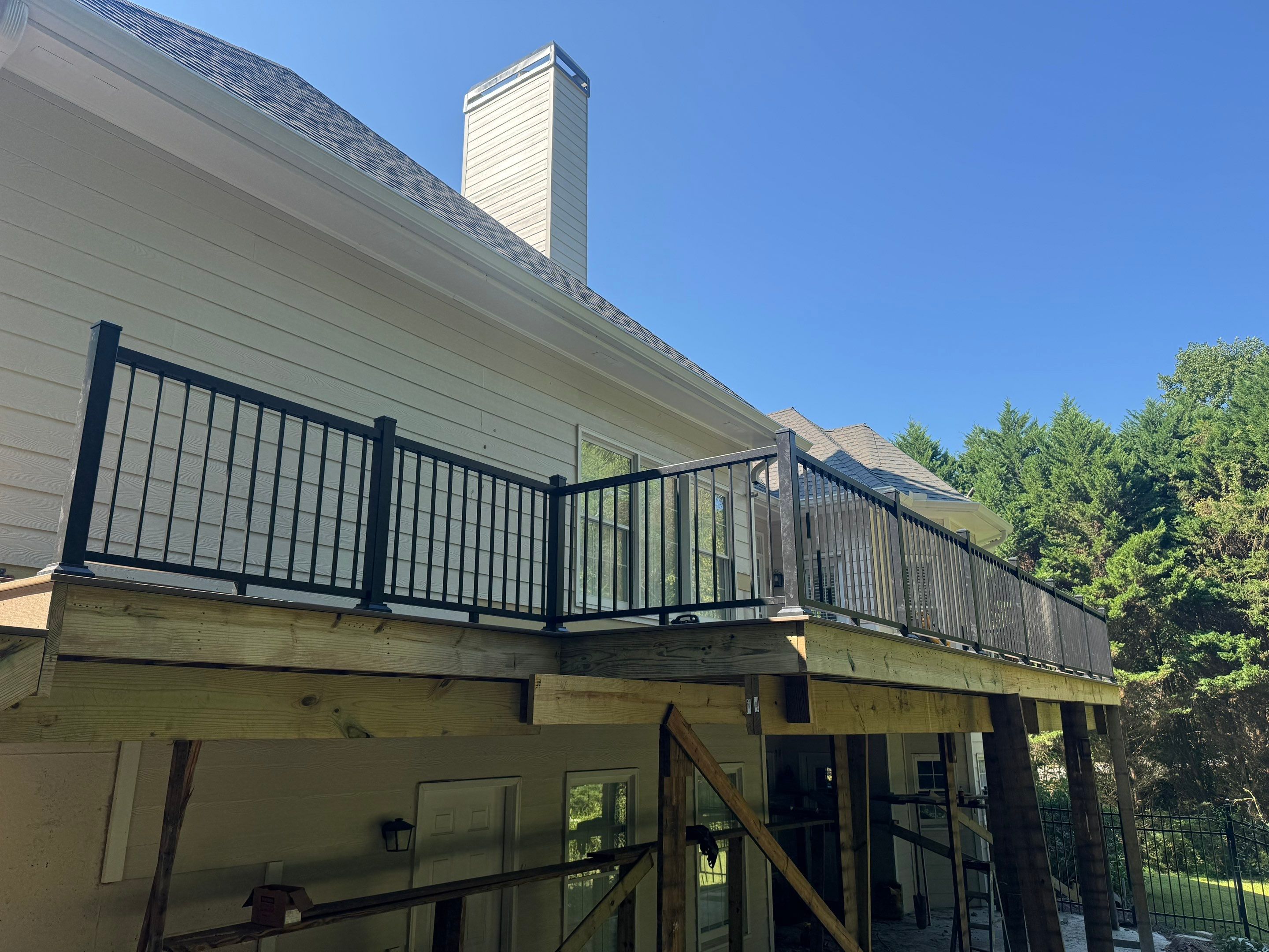Elevated Composite Deck Replacement with Metal Railings in Smyrna by Swift Home Renovations 