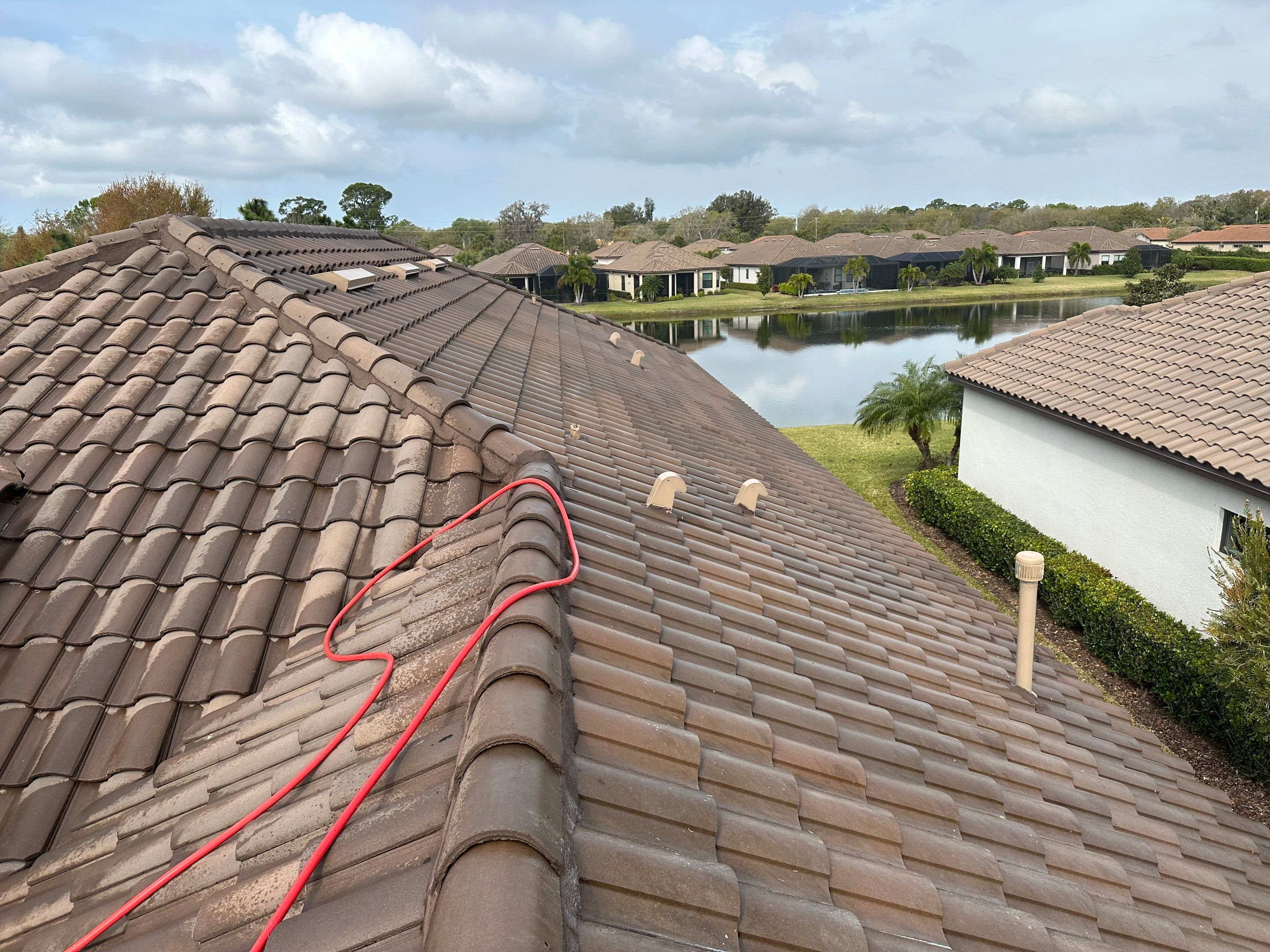 Concrete Tile Roof, Paver Pool Deck, Screen Enclosure & Driveway Cleaning in Artisan Lakes Esplanade, Palmetto, FL | Sunshine AquaWash by Sunshine AquaWash
