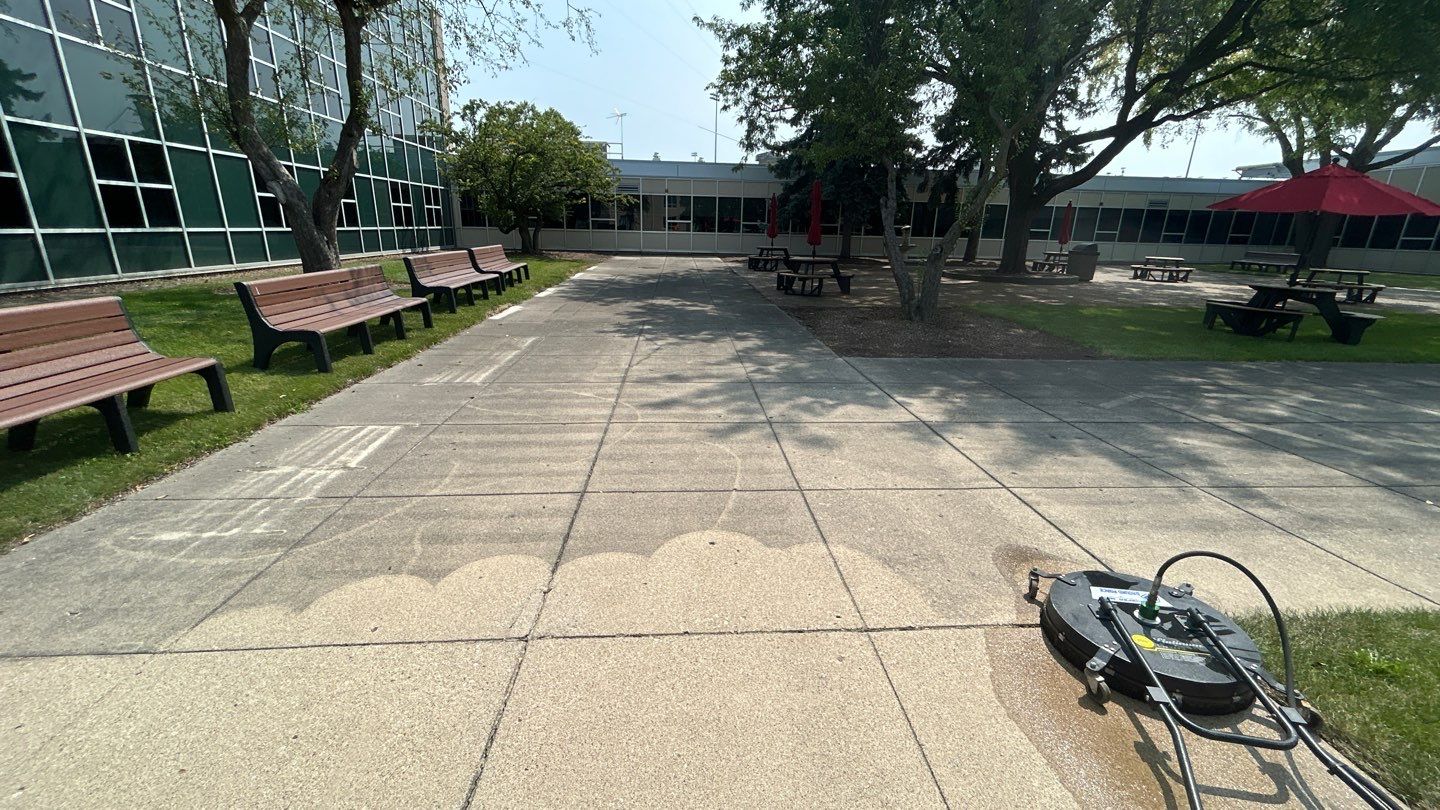 concrete using Algaecide, soft wash soap by Northern Power Washing LLC.