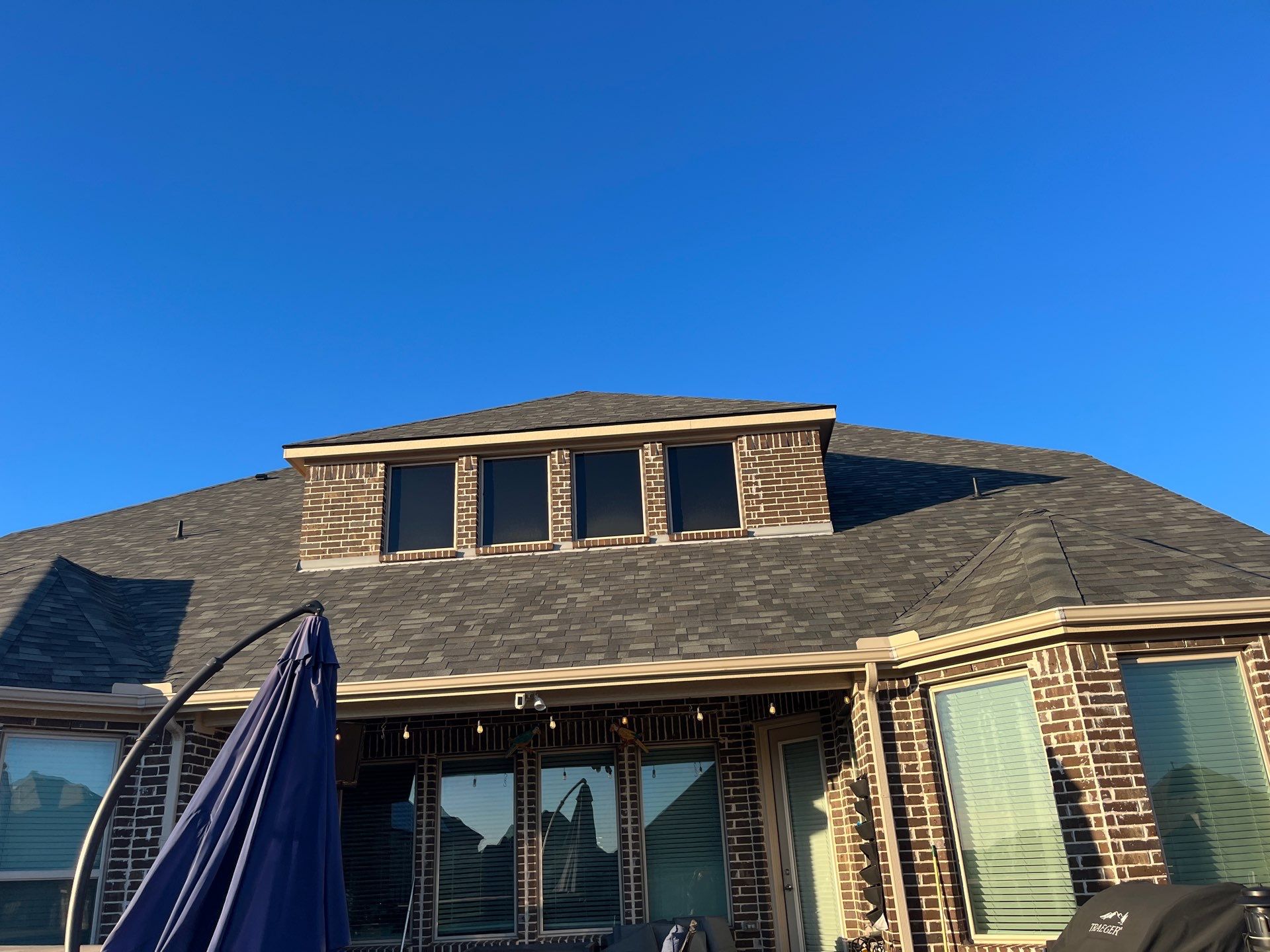 Red Brick with Malarkey Storm Grey by Tejas Roofworks + Restoration