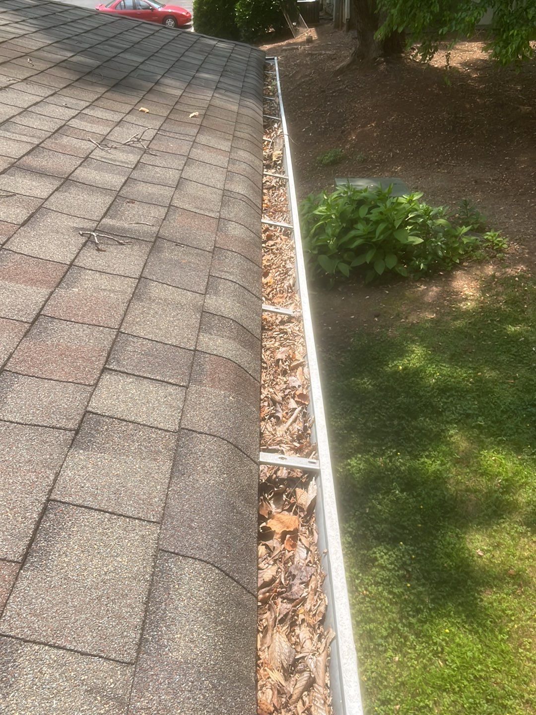 Commercial gutter cleaning Holly Springs & Fuquay-Varina, NC before photo with filled gutters