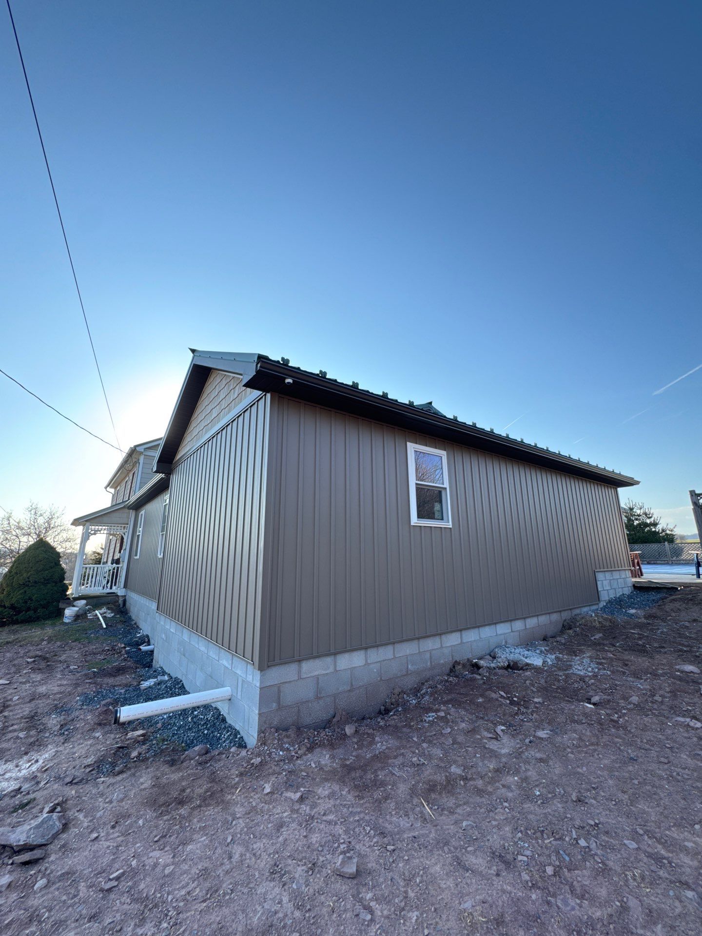 Multi-Story Residential Addition Featuring Textured Metal Siding in Millersburg by Esh Builders