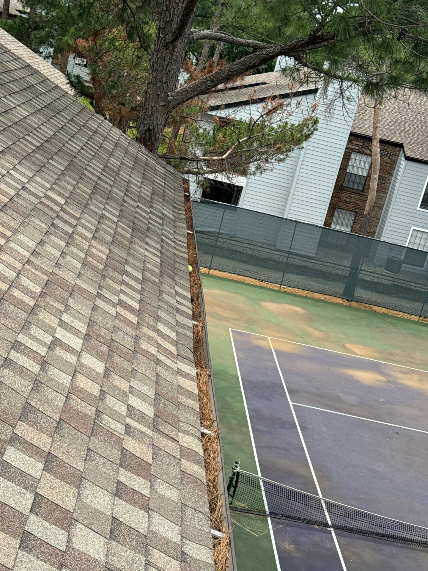 Commercial gutter cleaning Denton, TX before photo with filled gutters