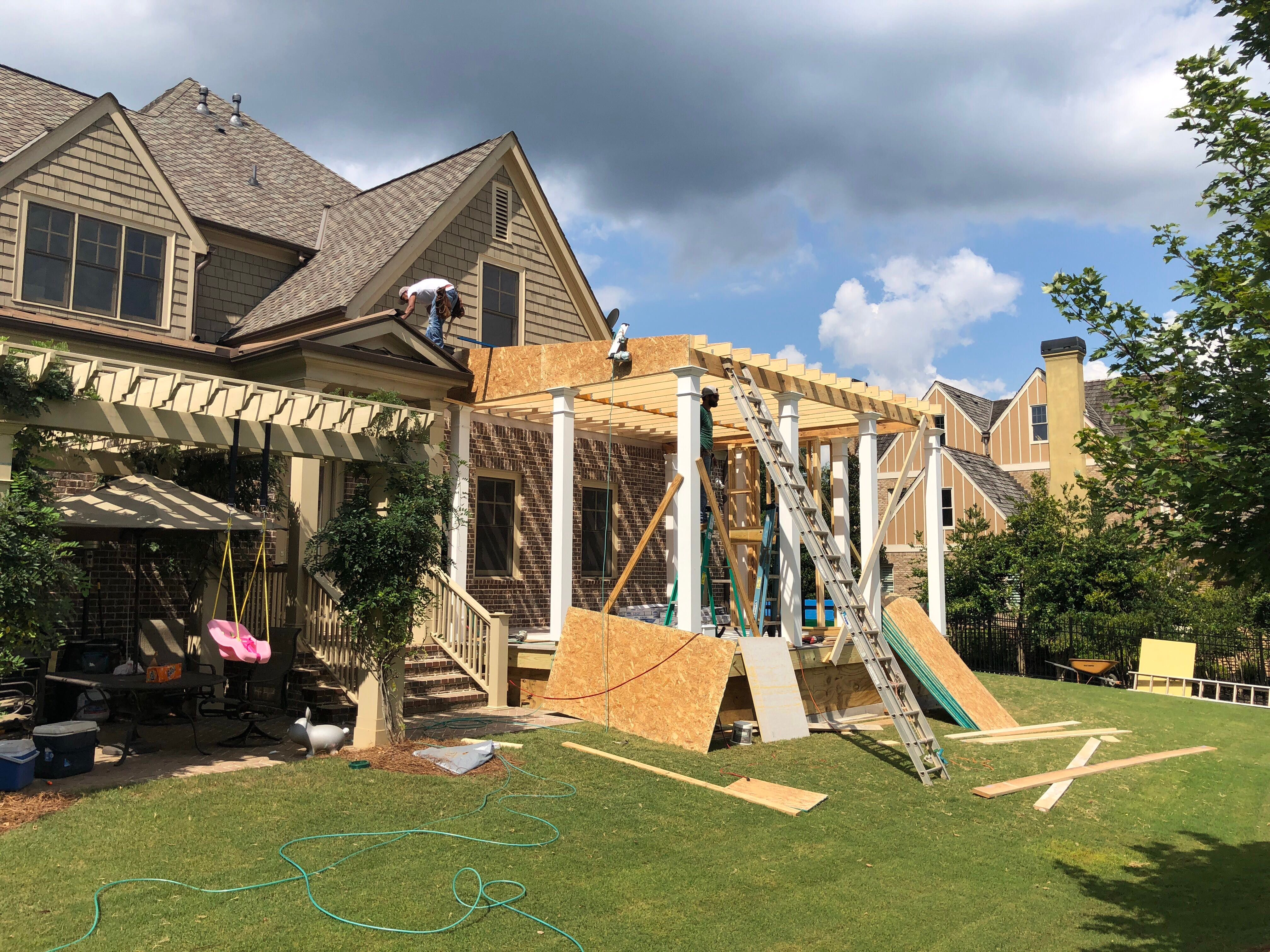 Custom Screened Porch Addition with White Brick Fireplace in Duluth by Swift Home Renovations