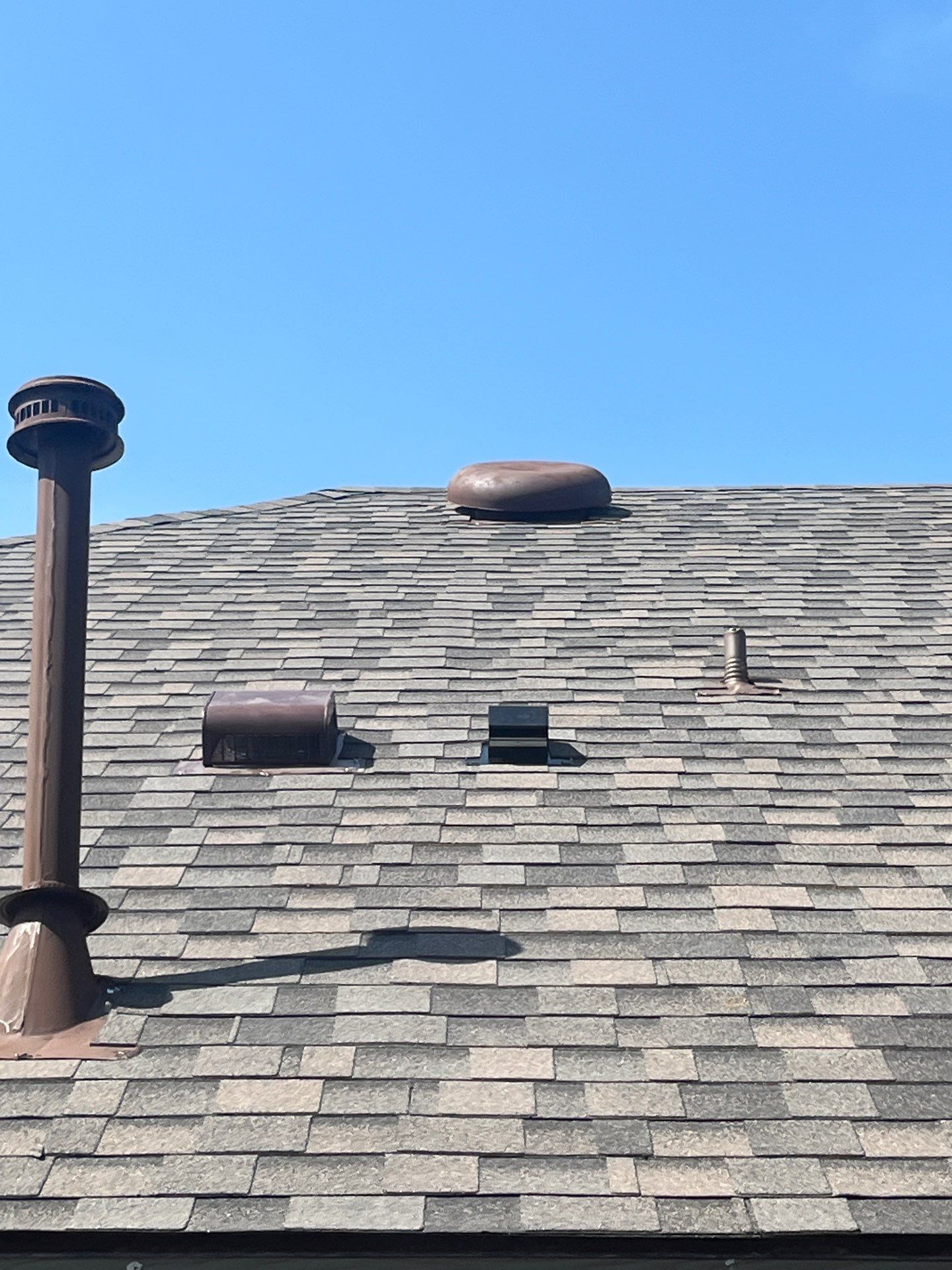Medium brown brick with IKO Driftshake by Tejas Roofworks + Restoration