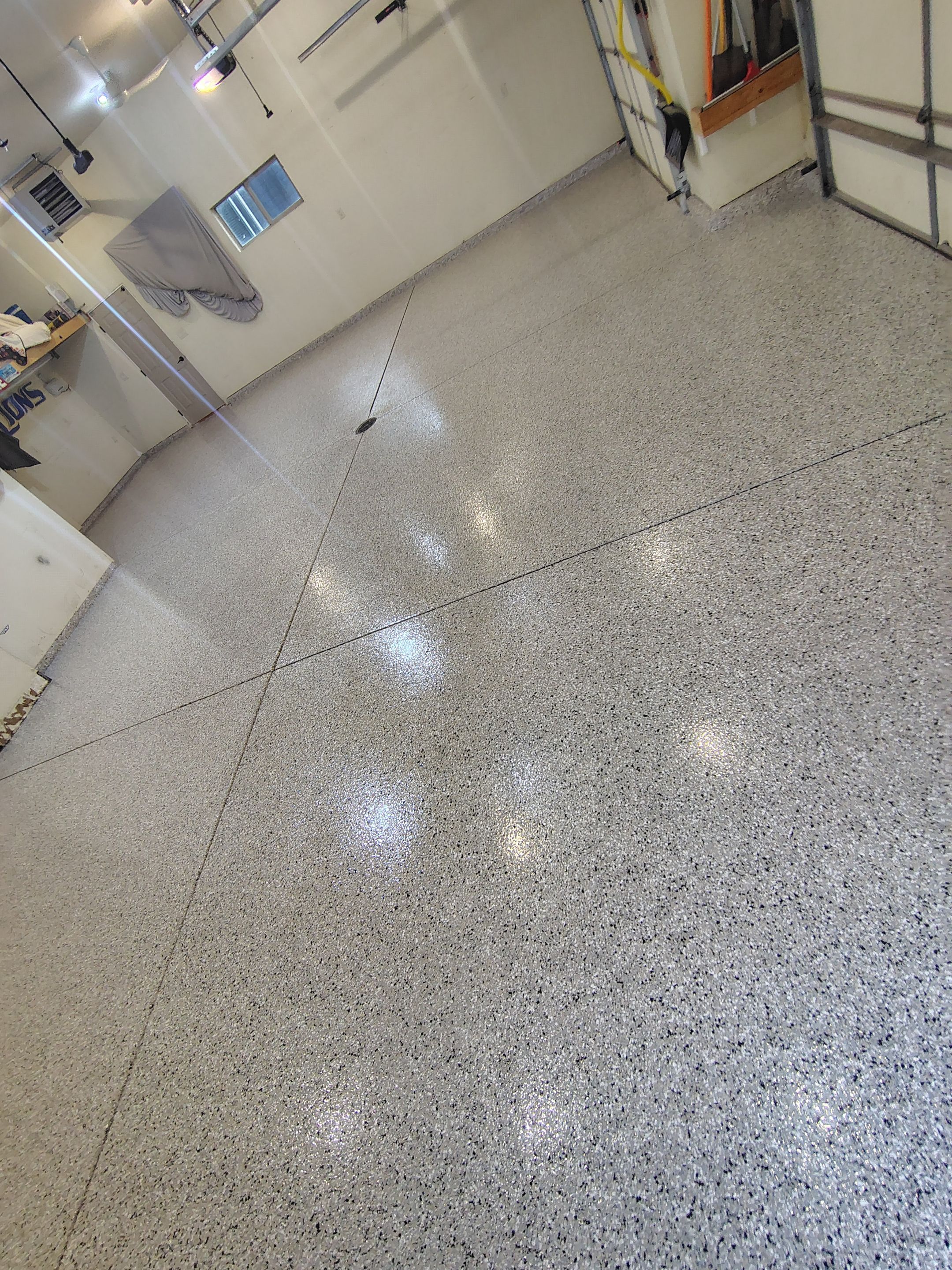 Sioux Falls Garage Floor Repair and Speckled Epoxy Coating Installation by Select Painting, Coatings & Garage Cabinets