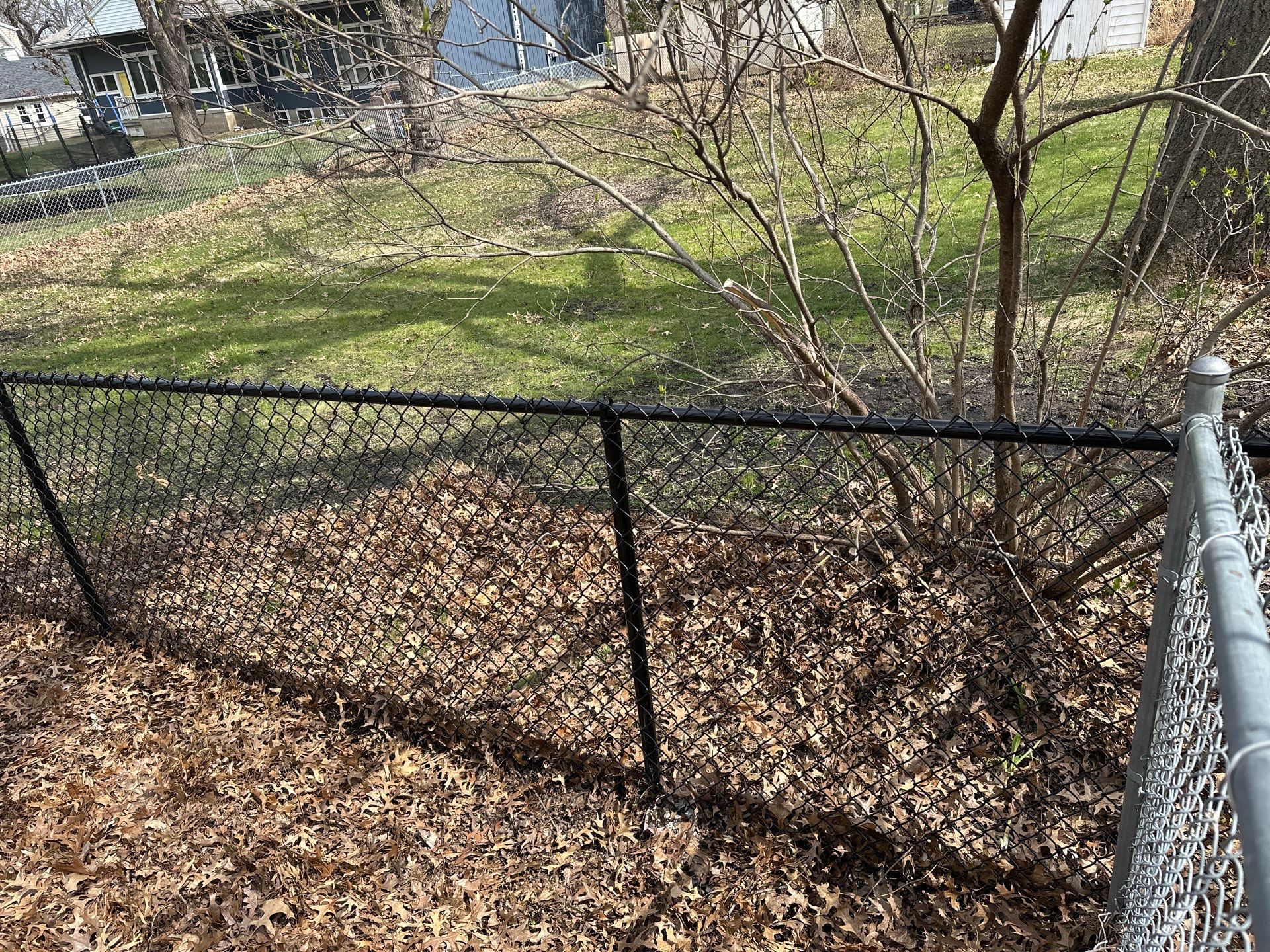 Black Vinyl-Coated Chain Link Fence Installation in Cedar Falls by Perfect Picket Fence and Stain