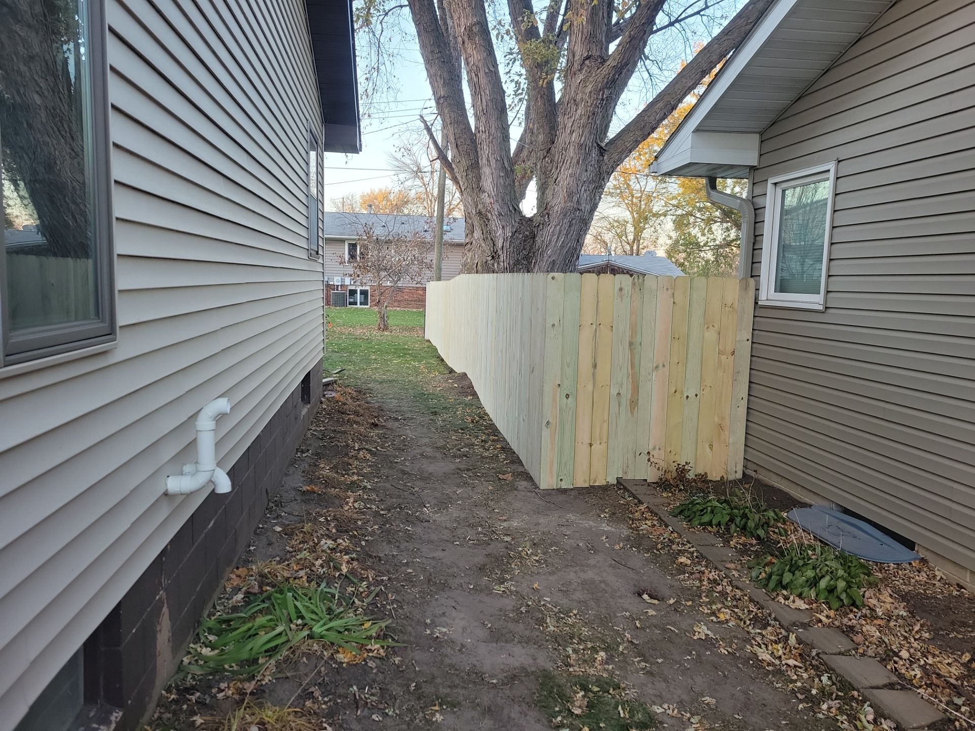 New Pressure-Treated Wood Privacy Fence and Gate in Charles City by Perfect Picket Fence and Stain