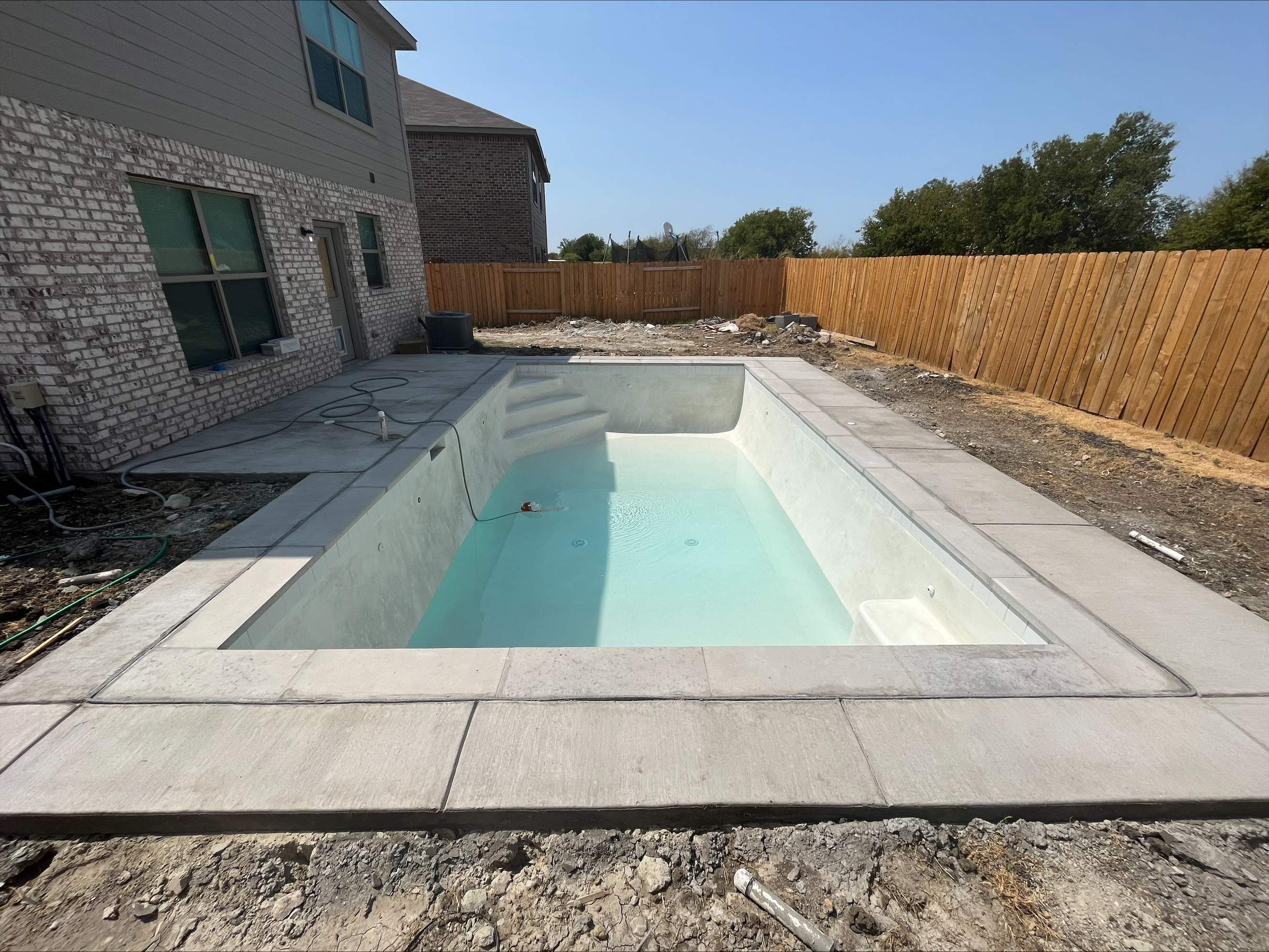 Geometric Pool with Stone Deck and Coping by Pinnacle Pools and Spas - DFW