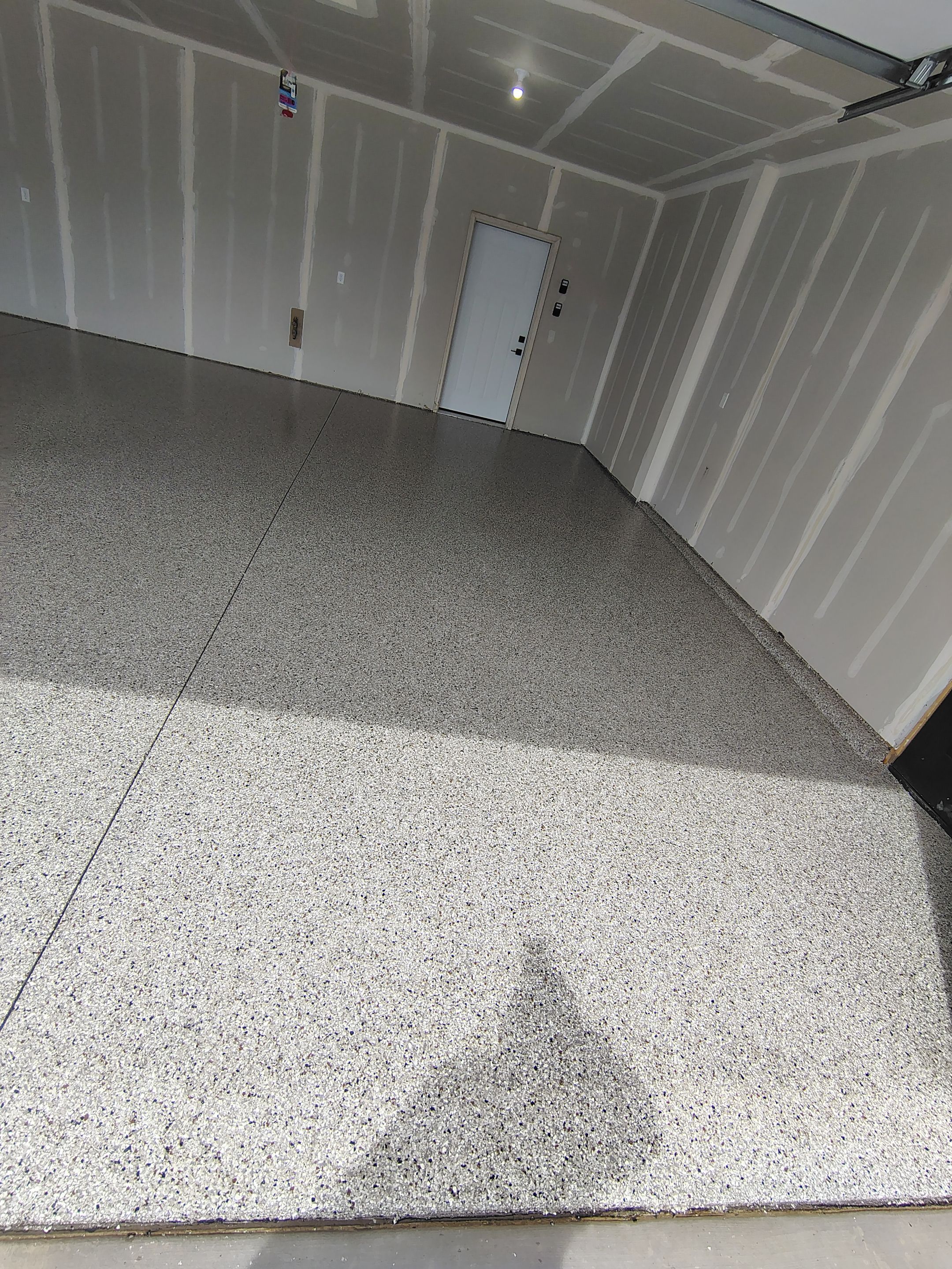 Speckled Epoxy Garage Floor Coating Installation in Sioux Falls by Select Painting, Coatings & Garage Cabinets