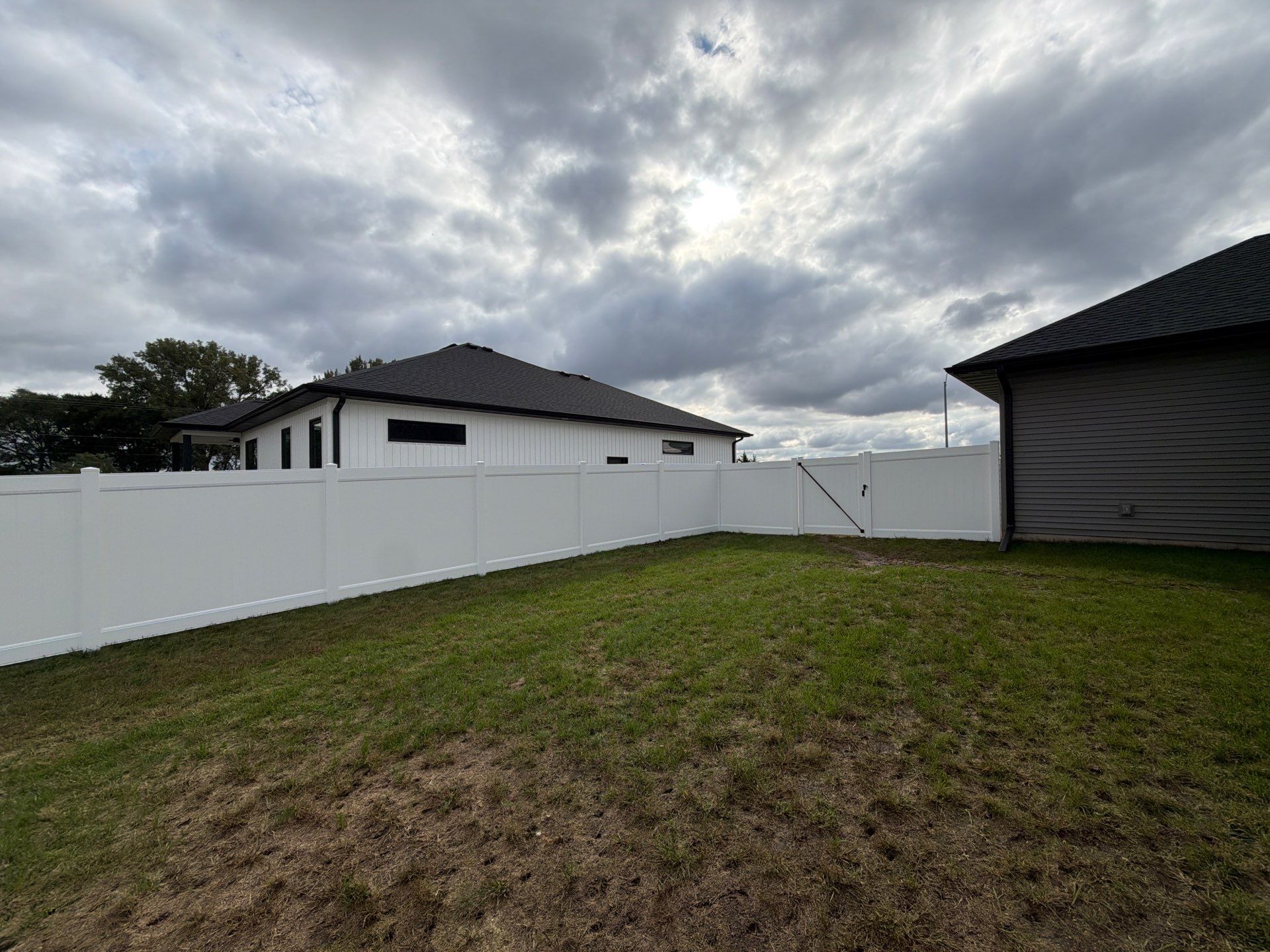 Residential White Vinyl Privacy Fence Installation in Janesville by Perfect Picket Fence and Stain