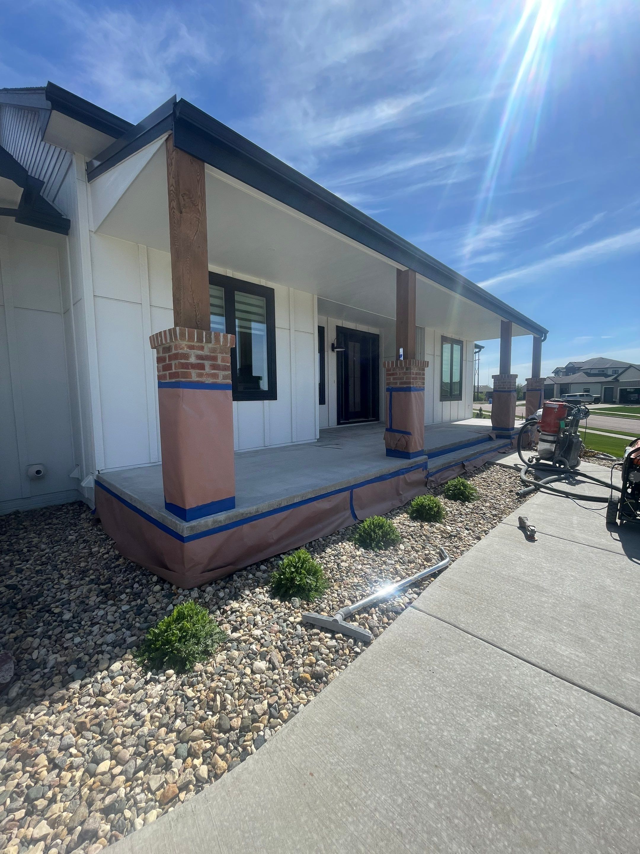 Grey Speckled Concrete Porch Coating for Sioux Falls Home by Select Painting, Coatings & Garage Cabinets