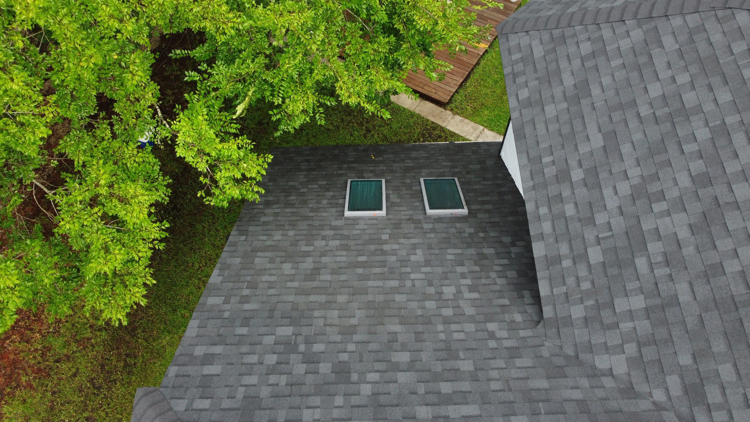 Complete Onyx Black Asphalt Shingle Roof Replacement and Skylight Installation in Jacksonville by Trinity Restoration and Roofing LLC
