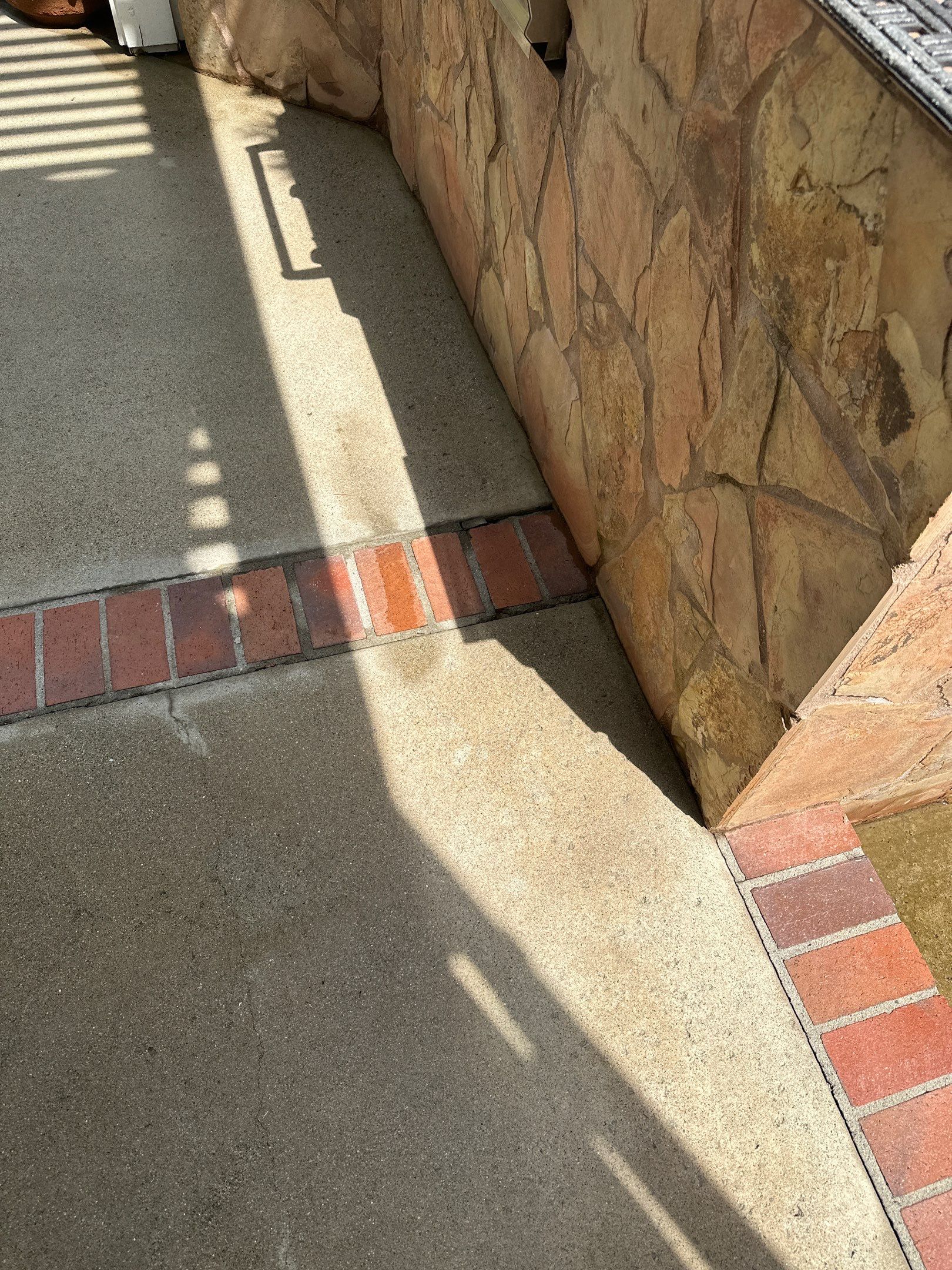 Surface cleaning pressure washing in Orange County on patio, walkways, and driveway by Property Cleaning Experts, LLC