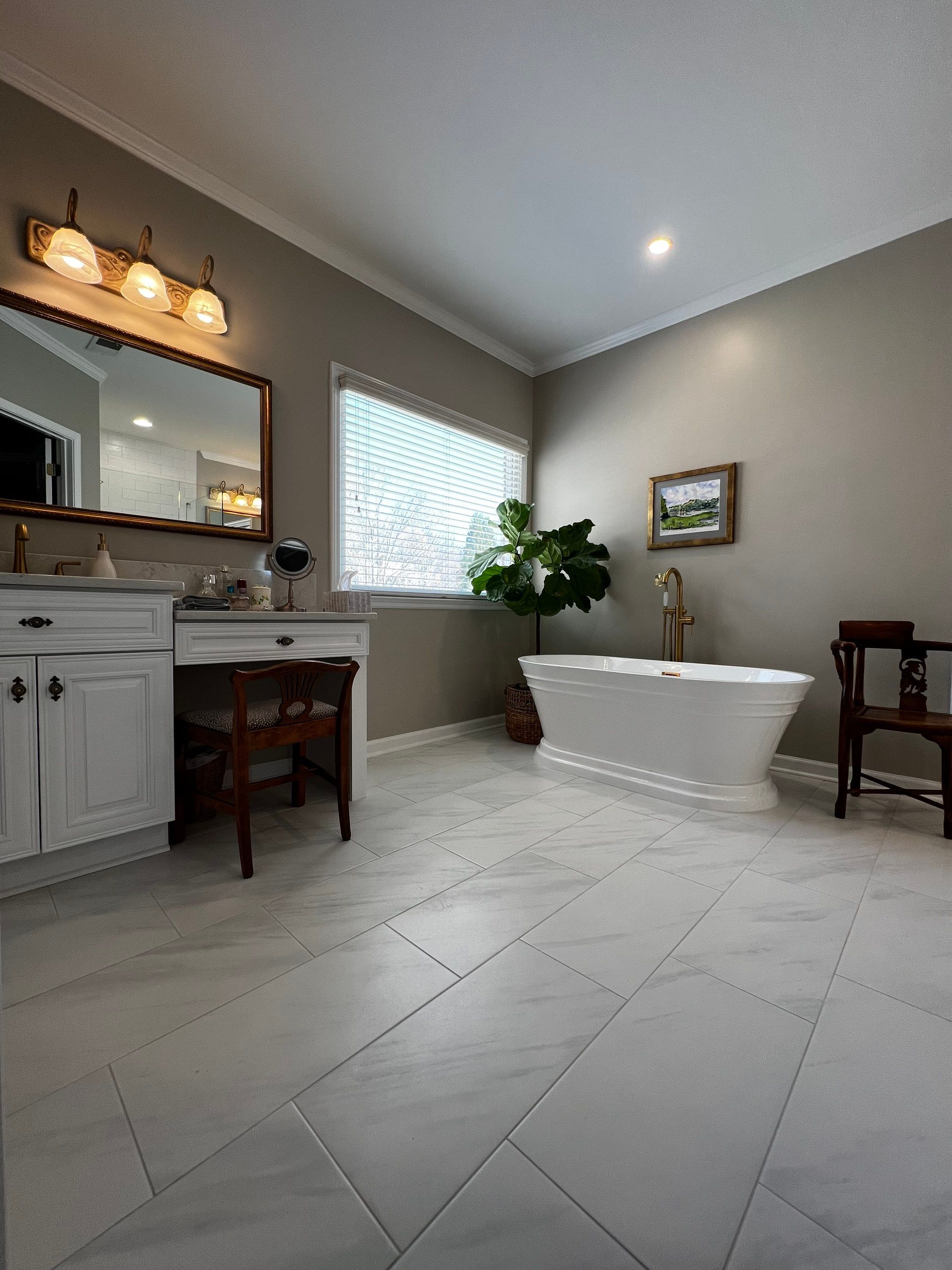 Master Bathroom Renovation with Marble Floor and Freestanding Soaking Tub by Swift Home Renovations