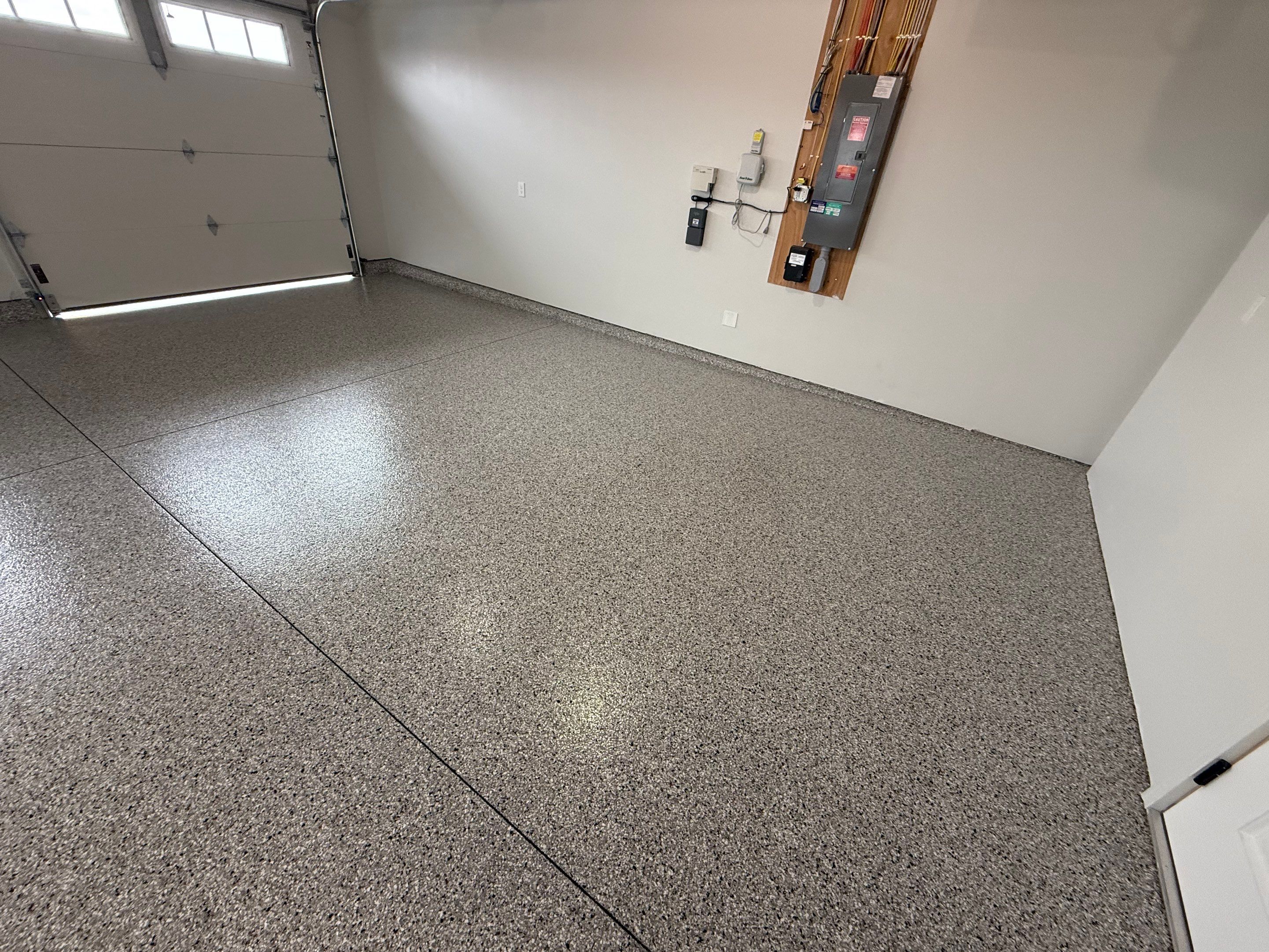 High-Gloss Epoxy Flake Garage Floor Coating in Brandon by Select Painting, Coatings & Garage Cabinets