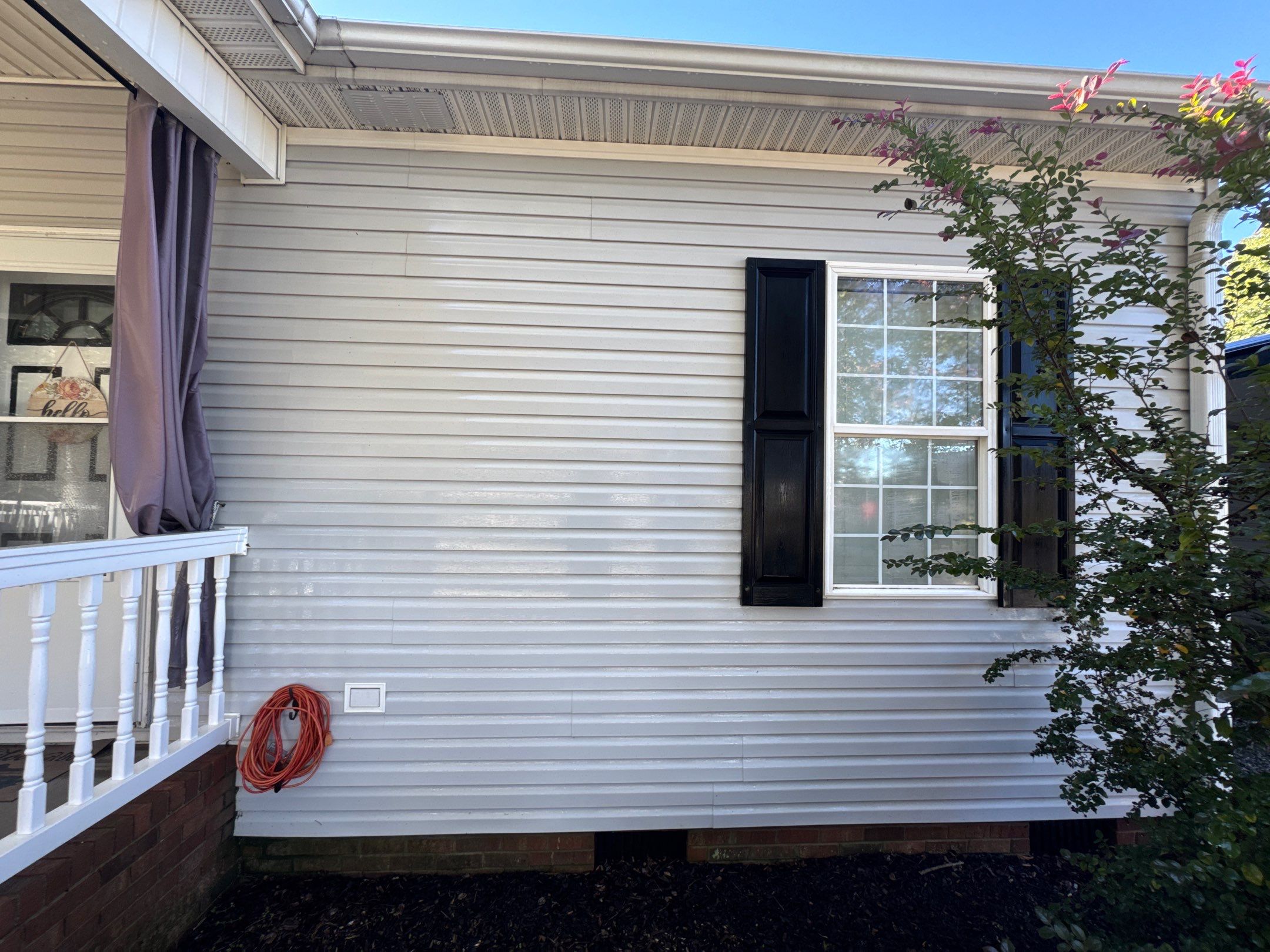 the service shown is cleaning the vinyl siding of a house to remove dirt and grime for improved appearance