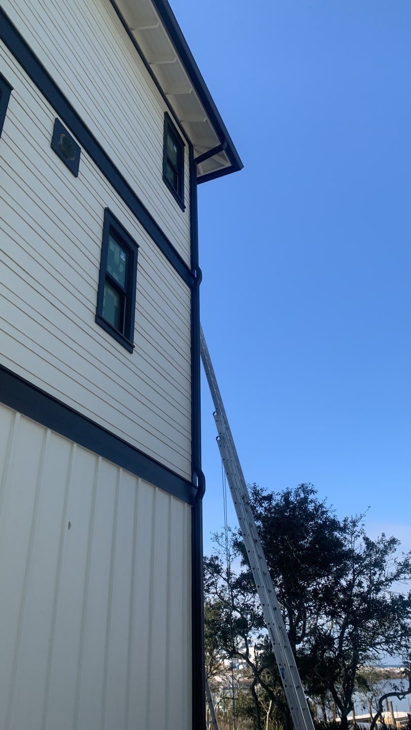 Seamless Gutter Installation Using Black Half Round Seamless Gutters by Gutter Professors