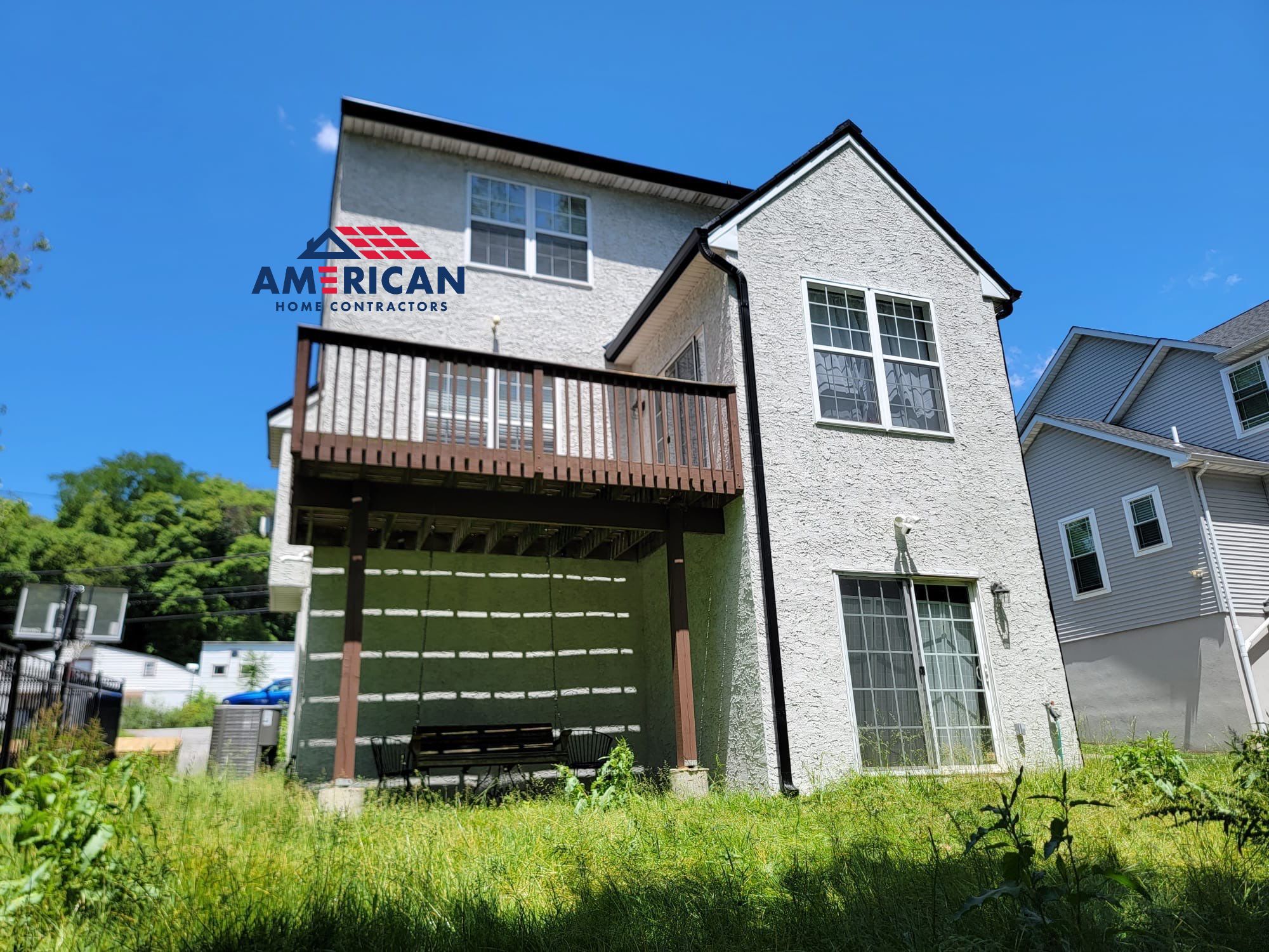 Tesla Solar Roof, Powerwall, and Black Gutters by American Home Contractors