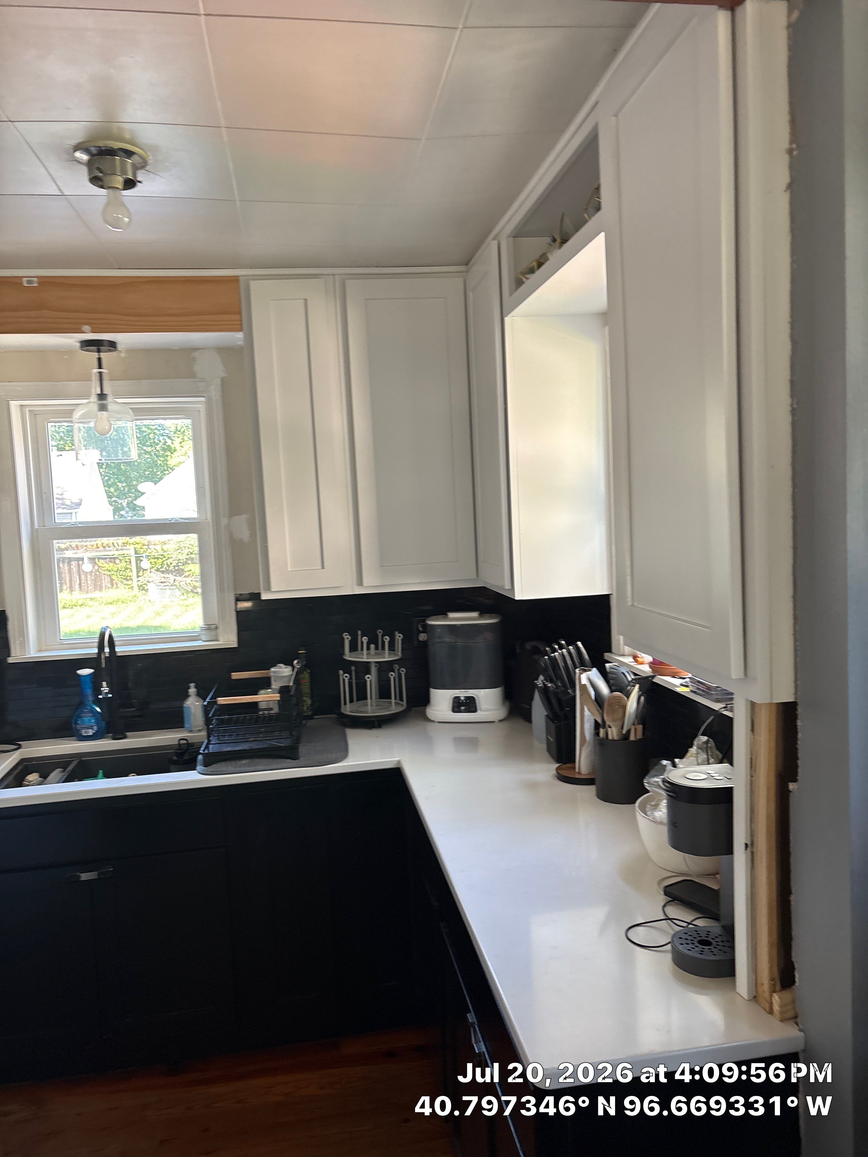 Kitchen Remodel in Lincoln Nebraska Featuring Two-Tone Cabinetry and Black Backsplash by CompanyCam Sales Demo