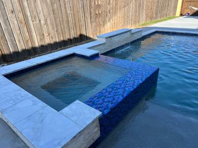 Geometric Pool with Raised Spa and Blue Glass Tile