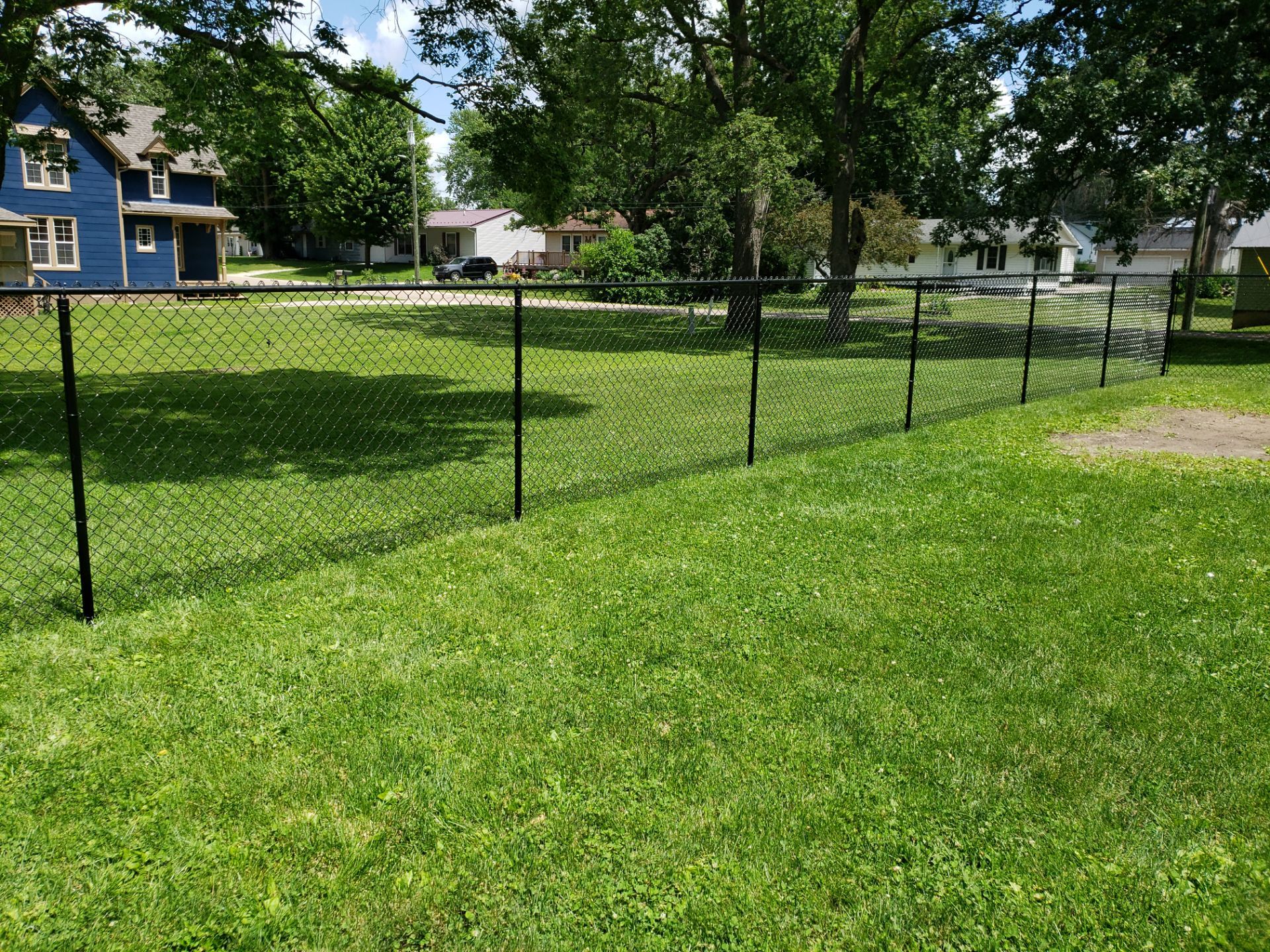 Black Vinyl Coated Chain Link Fence Installation in Independence by Perfect Picket Fence and Stain