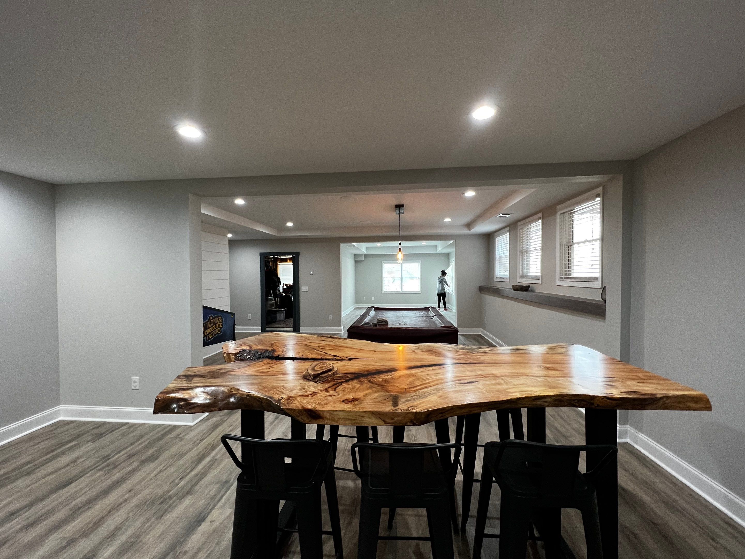 Modern Basement Remodeling in Woodstock with Custom Live-Edge Bar by Swift Home Renovations