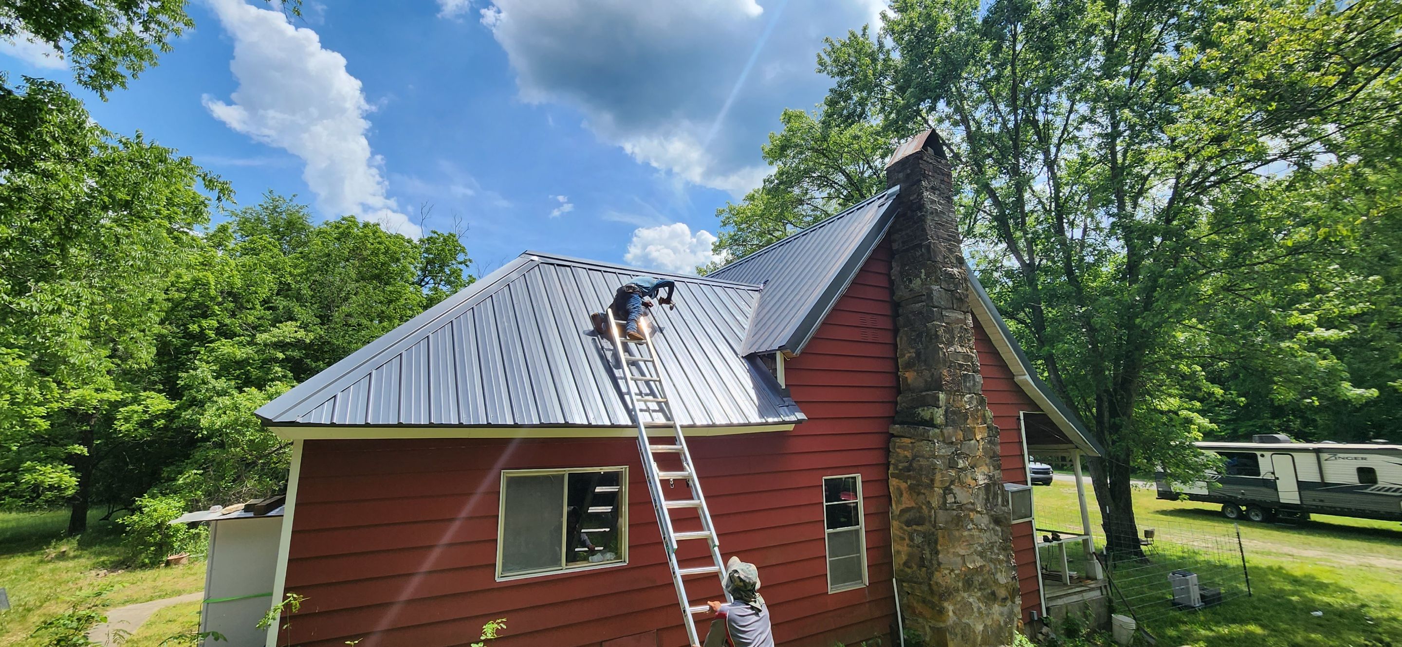 Residential Roofing Installation using 26 Gauge Colored Panels by Hostetler Roofing