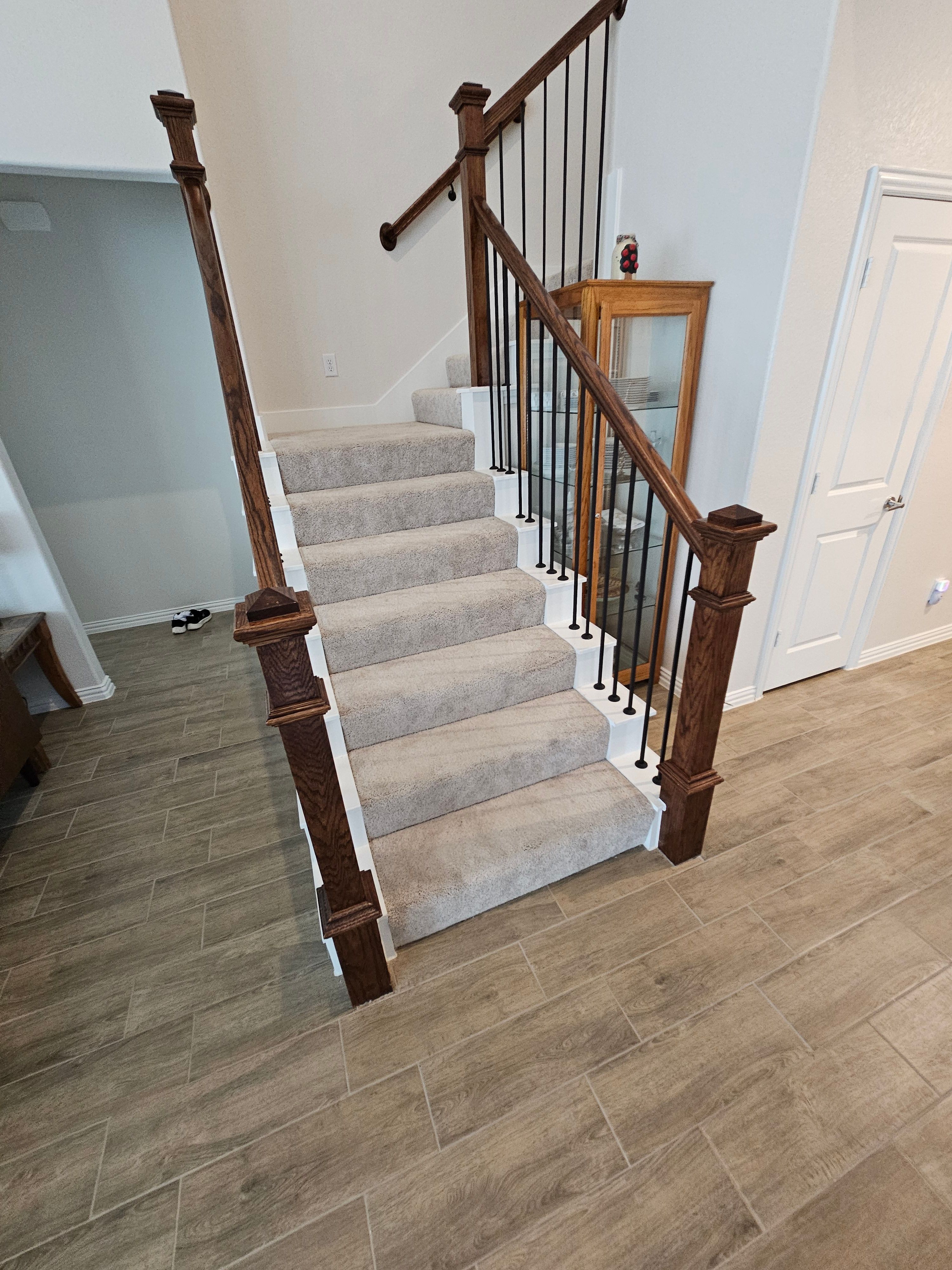 Carpet replacement with Tile and Red Oak Stairs by EL-GC LLC 