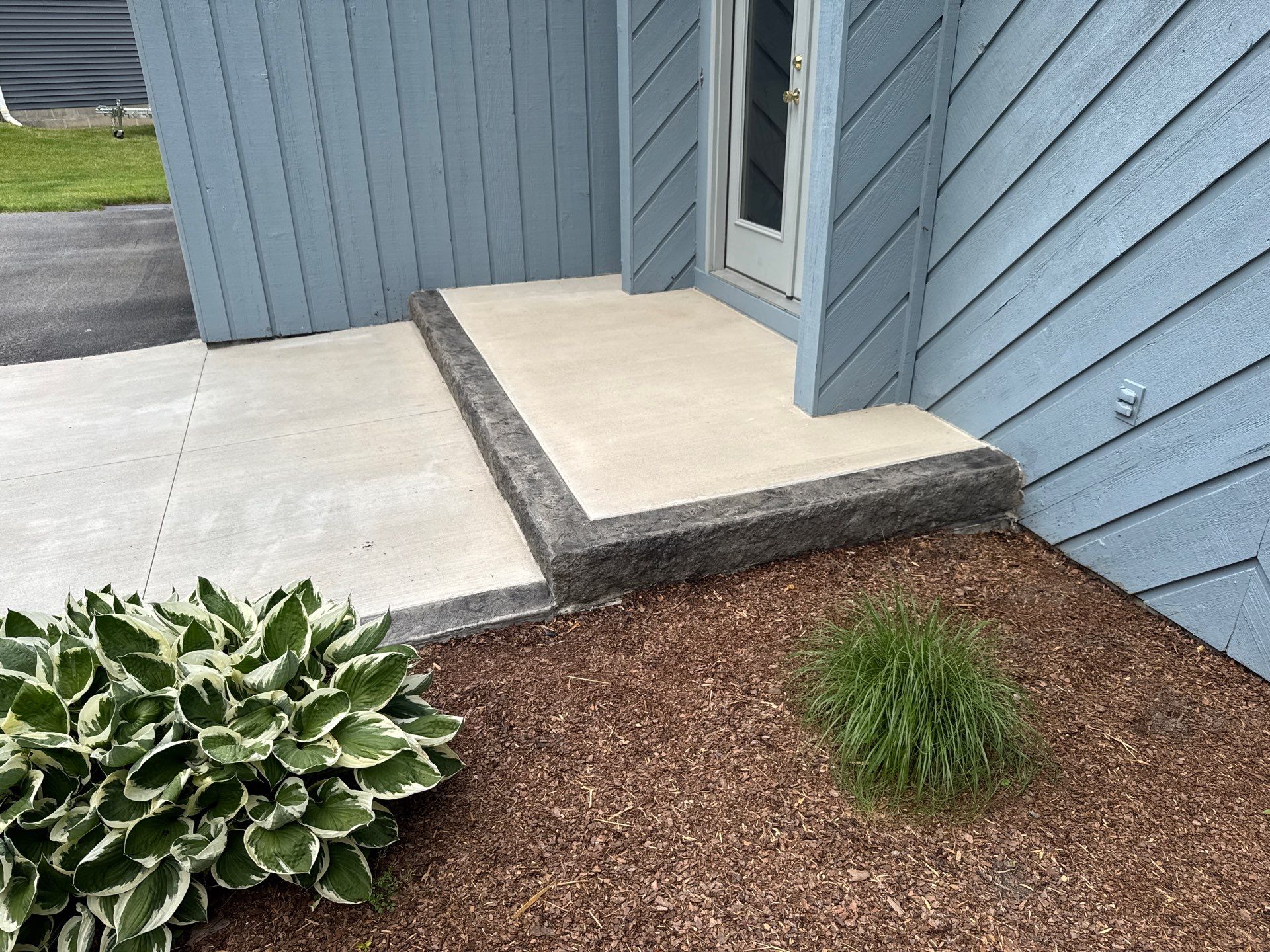 Charcoal Release Border with Broom Finish  by NG Masonry & Construction LLC