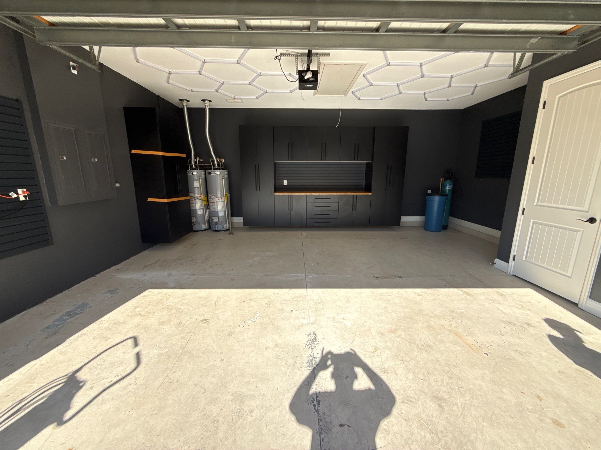 Custom Garage Makeover in Lutz Featuring Hex Lighting and Epoxy Floors by Square 1 Garage and Closet Solutions