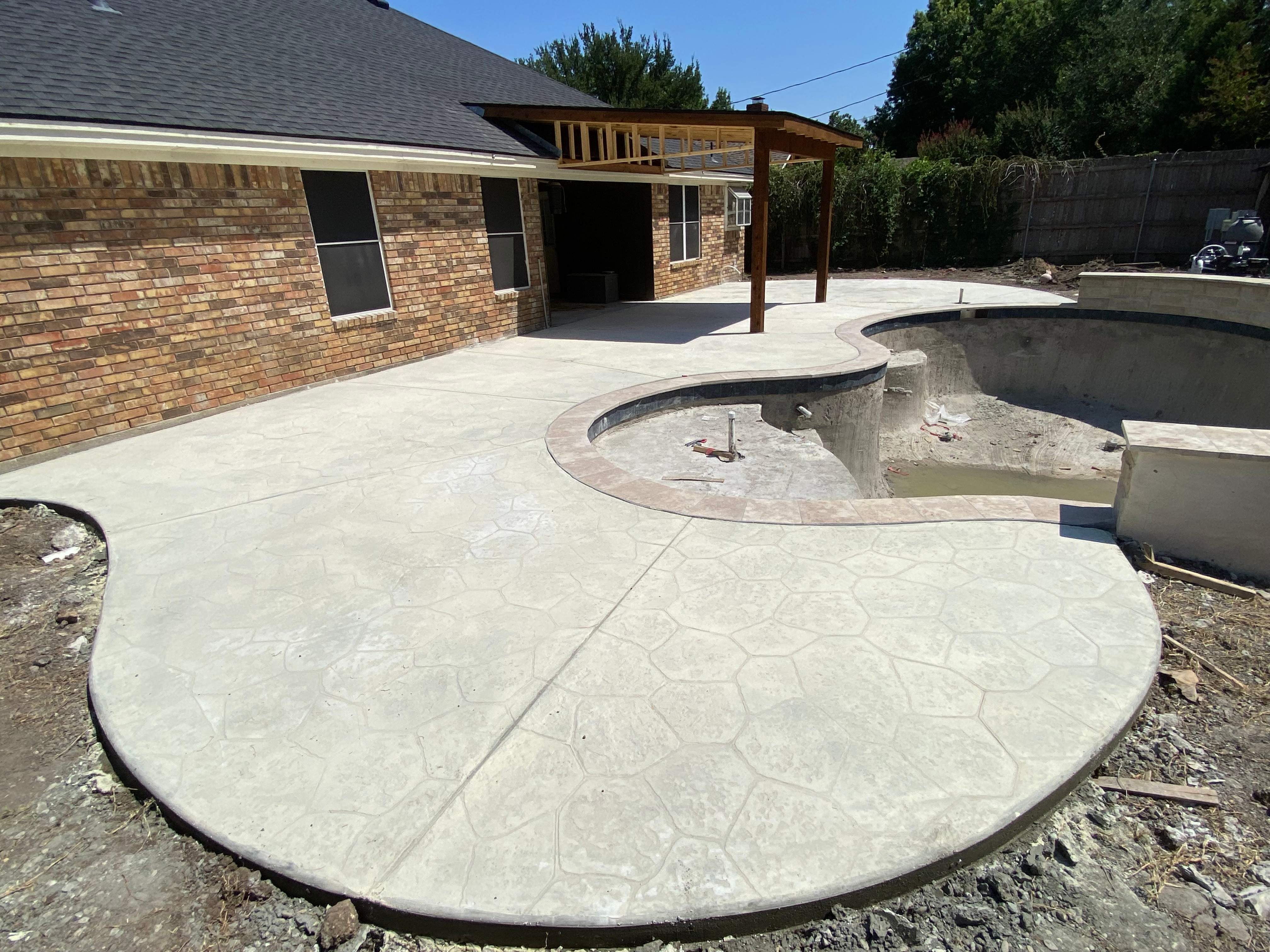 Freeform Pool with Raised Spa and Stone Decking by Pinnacle Pools and Spas - DFW