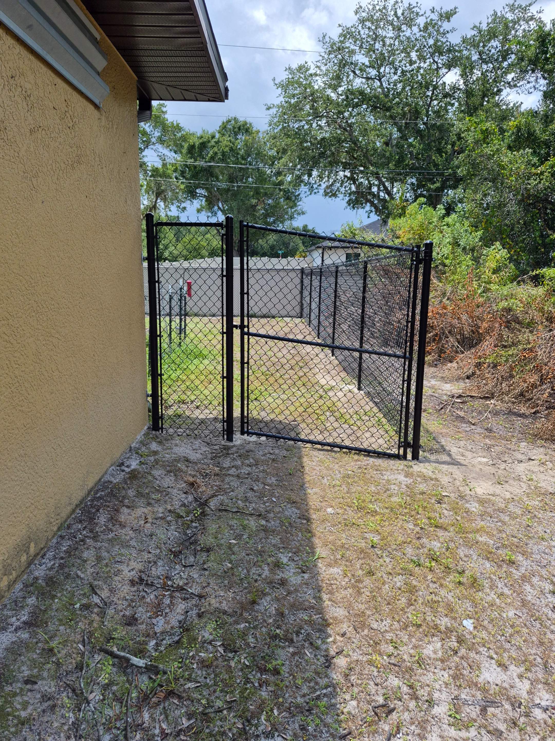 Black Chain Link Perimeter Fencing with Double Gates in Port Charlotte by True Fence LLC