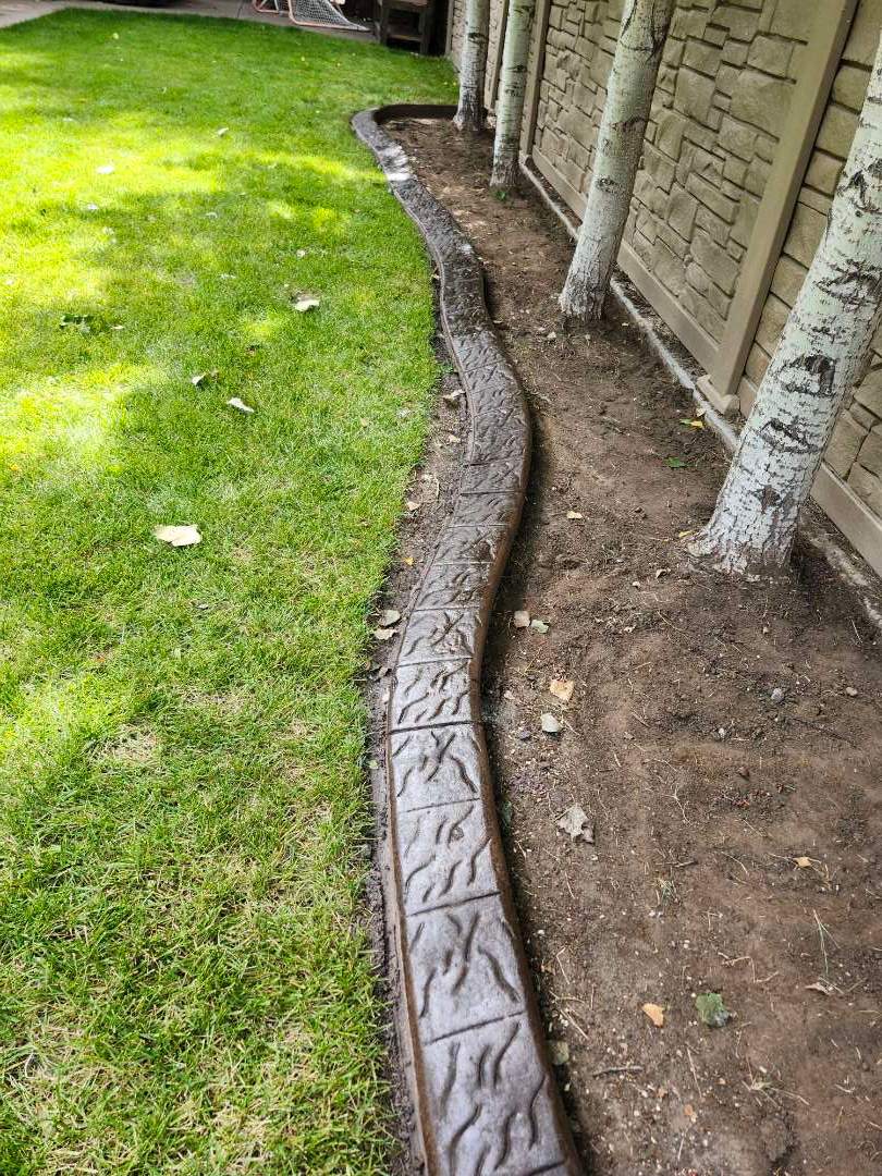 Decorative Stamped Concrete Landscape Edging Installation in Medicine Hat by Pump it Up Concrete Jacking