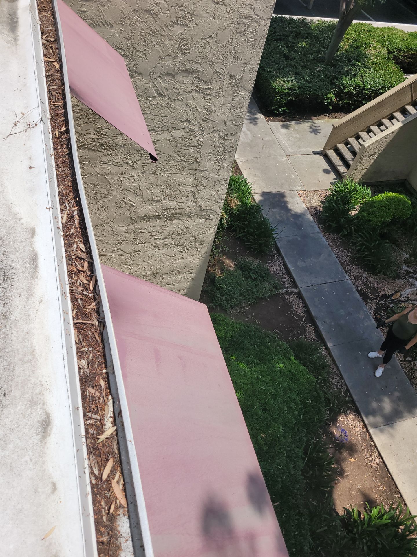 Commercial gutter cleaning Carlsbad & Oceanside, CA before photo with filled gutters