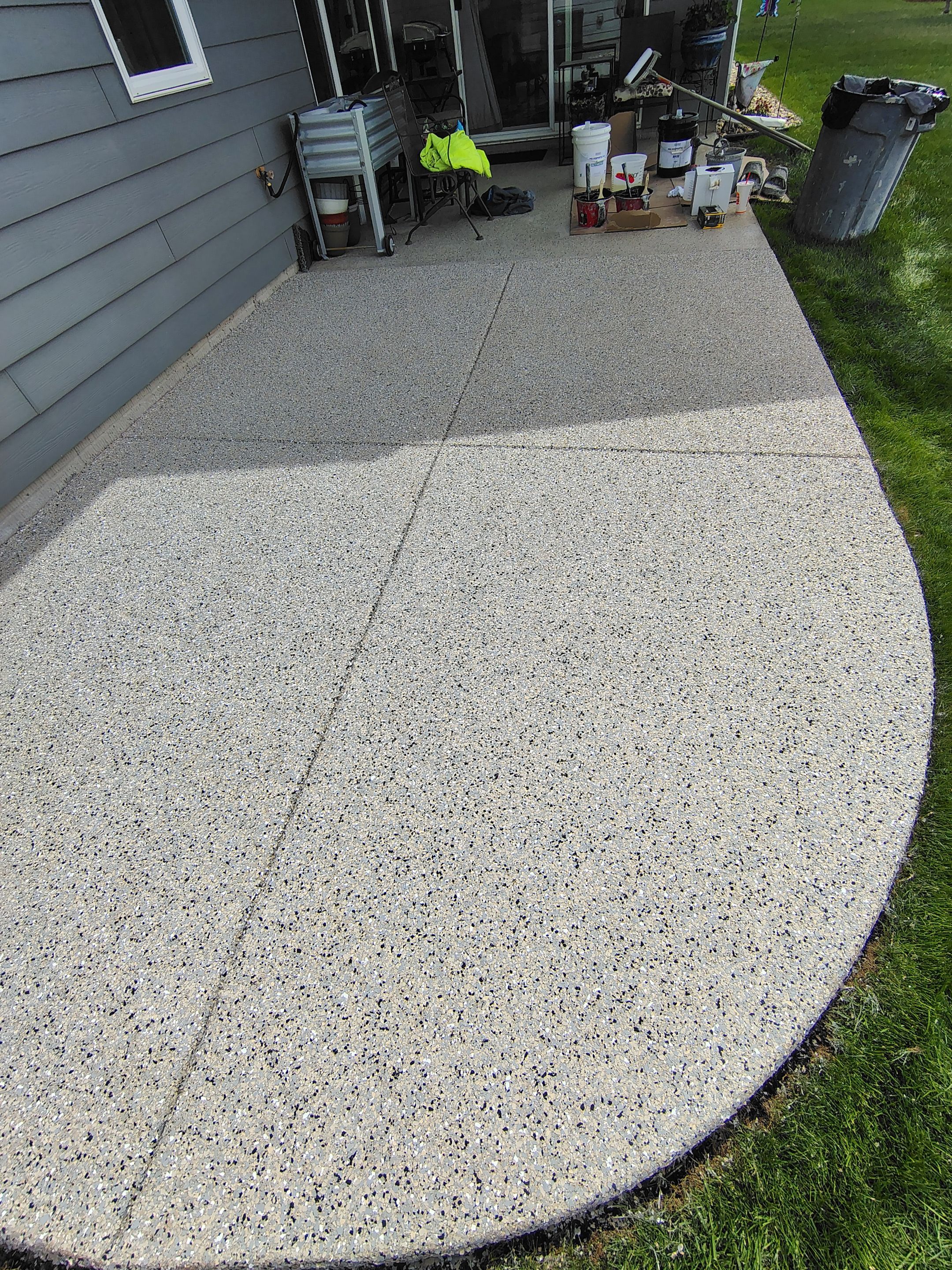 Speckled Concrete Patio Coating Installation in Sioux Falls by Select Painting, Coatings & Garage Cabinets