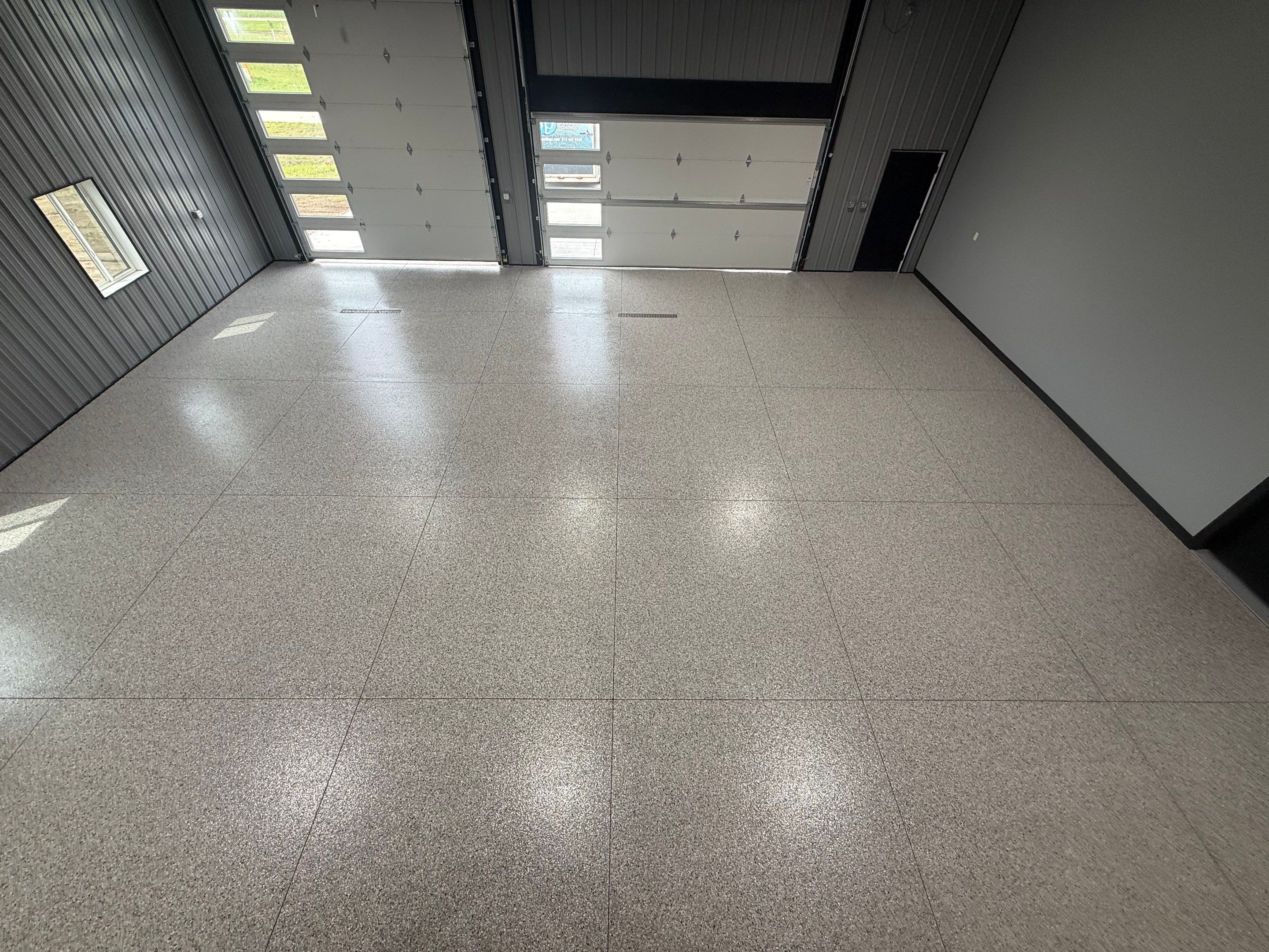 Polyaspartic Garage Floor Coating with Decorative Flake in Wentworth by Select Painting, Coatings & Garage Cabinets