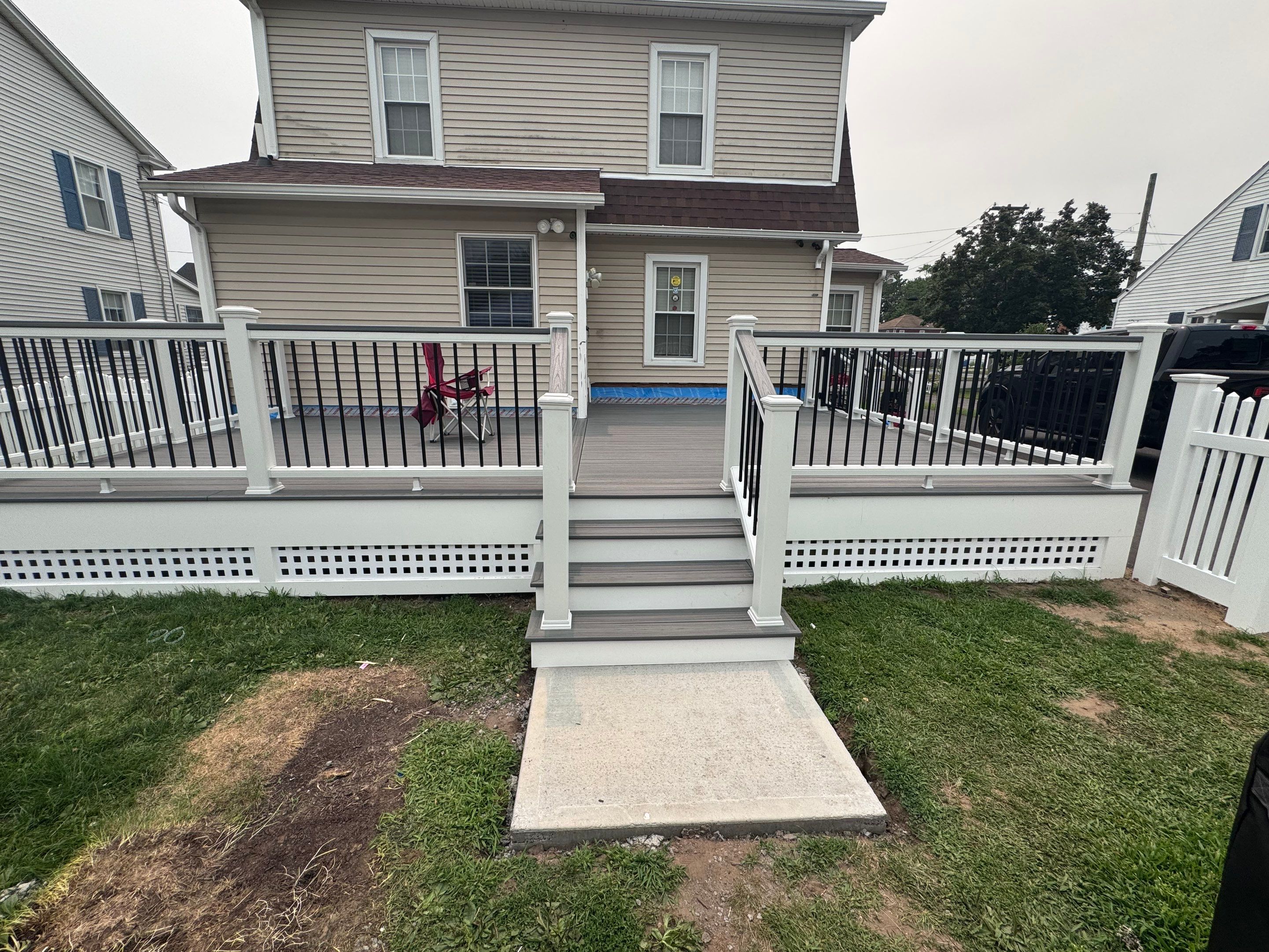 Deck Replacement usin gTrex Tropical Islandmist and Transcend Cocktail rail, Includes lattice and a gate. by DiGiorgi Roofing and Siding Inc