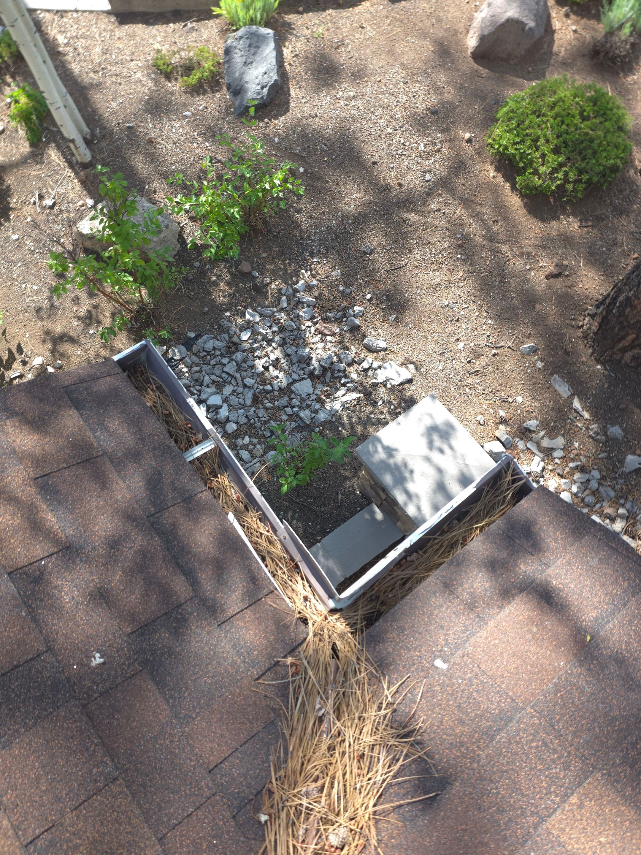 HOA gutter cleaning in Flagstaff, AZ before photo showing full gutters.