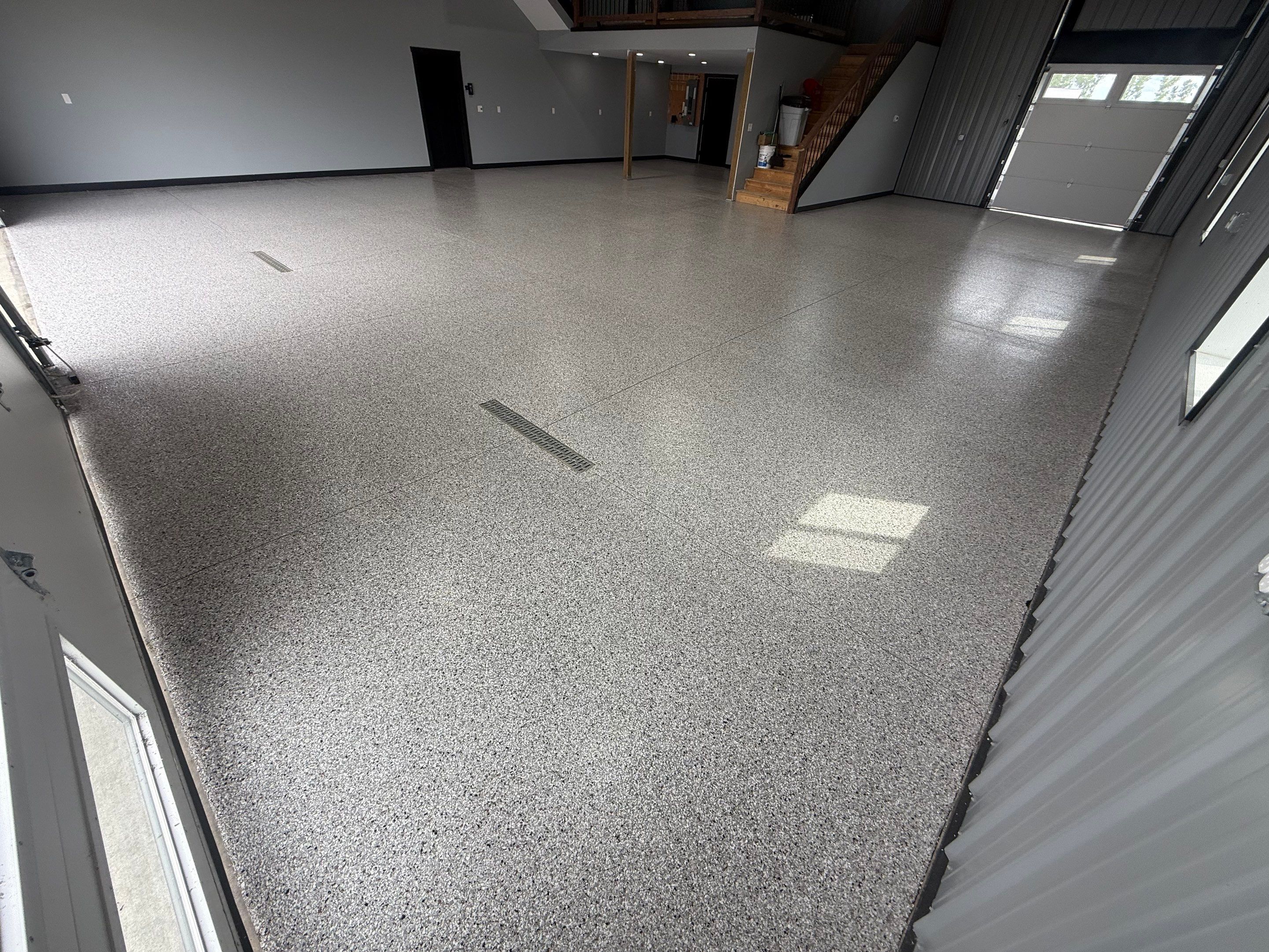 Polyaspartic Garage Floor Coating with Decorative Flake in Wentworth by Select Painting, Coatings & Garage Cabinets