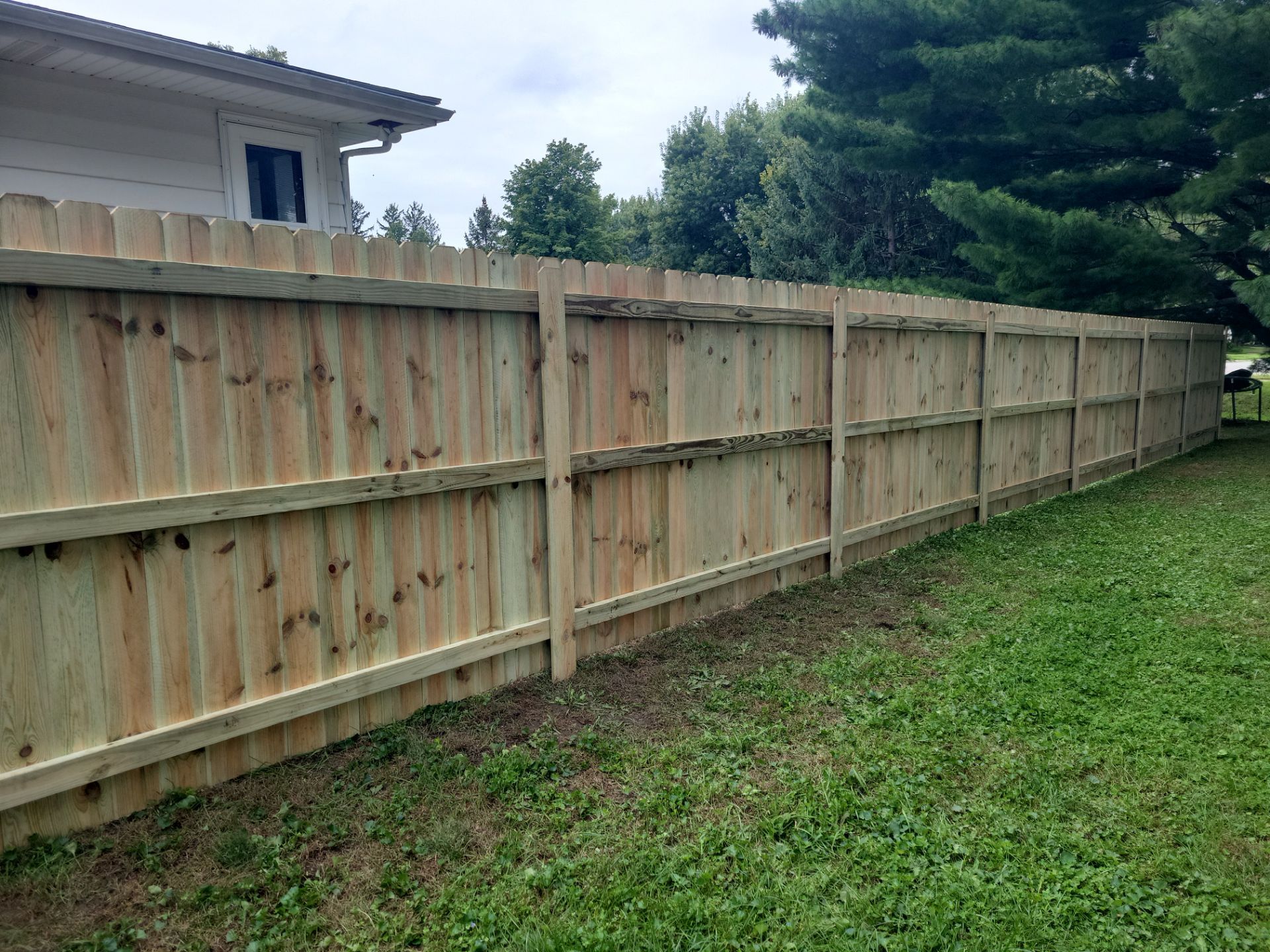 Pressure-Treated Wood Privacy Fence Installation in Waverly by Perfect Picket Fence and Stain