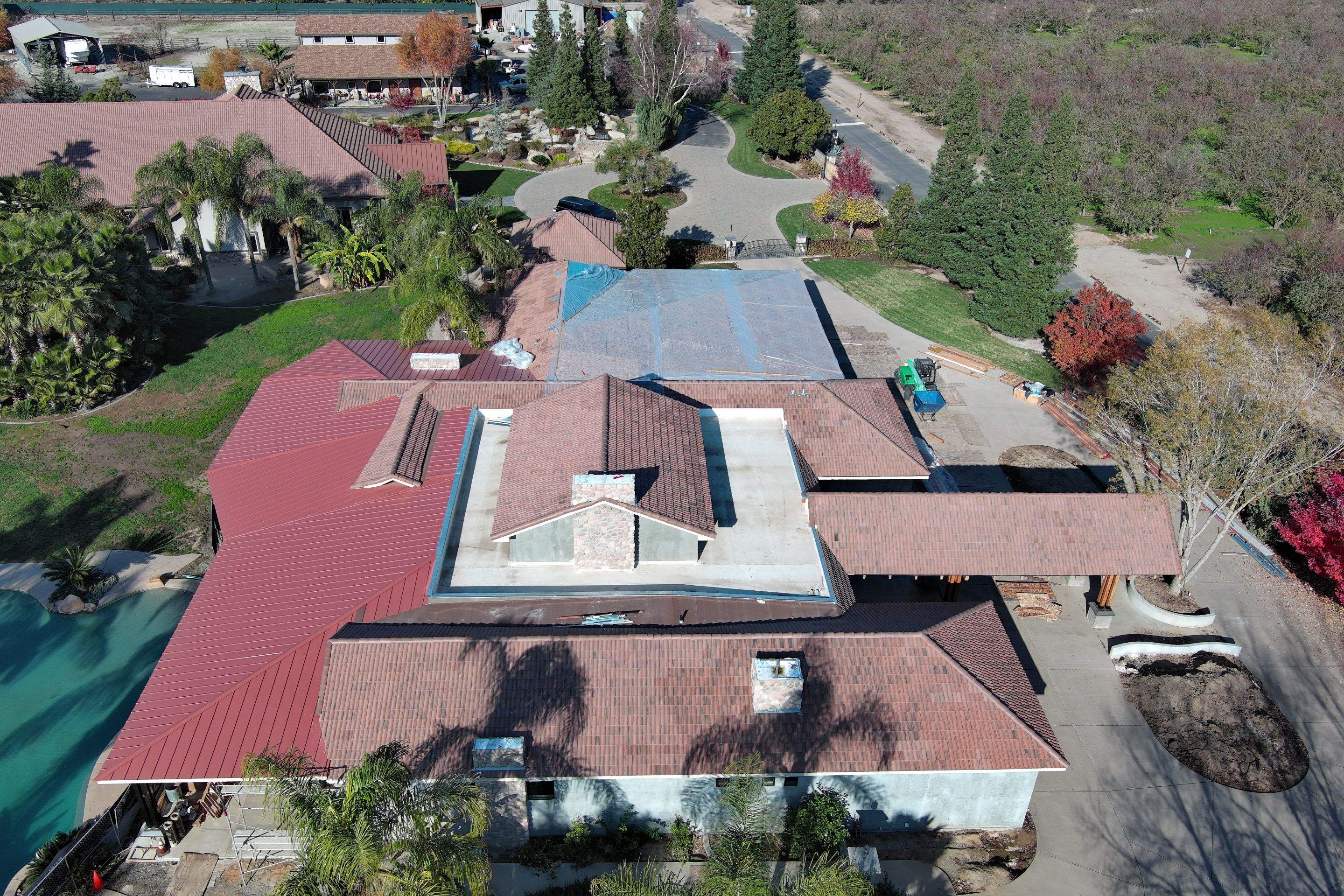Tile, Metal, and TPO roofing project (new construction) by Straight Edge Roofing Inc