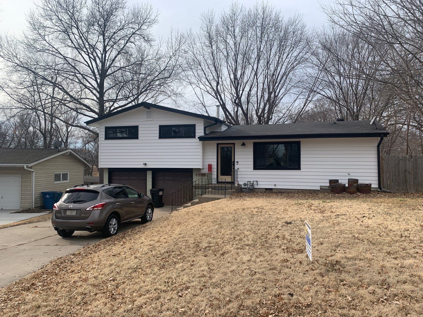 White Craneboard Siding and Heartland Window Installation in Parkville by EEC Windows, Siding & Roofing