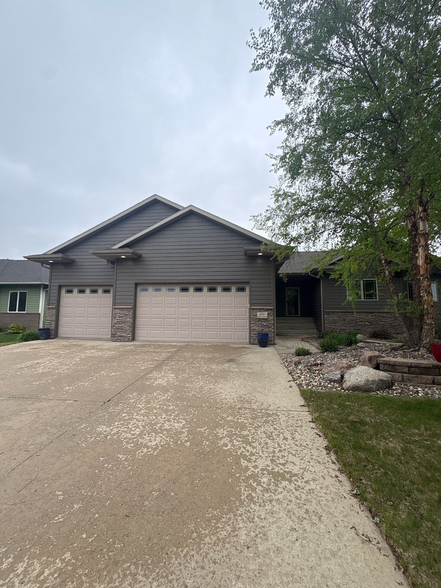 Sioux Falls Residential Exterior Update and Flagstone Pool Deck by Select Painting, Coatings & Garage Cabinets