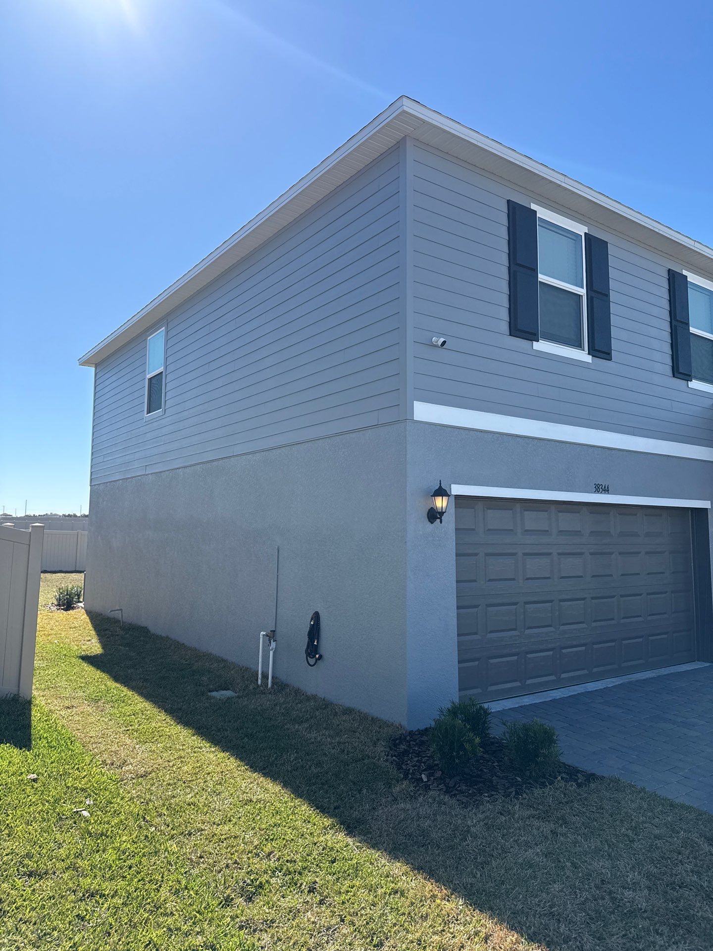 White Down Spouts and Seamless Gutters using downspouts in Dade City FL by Gutter Professors