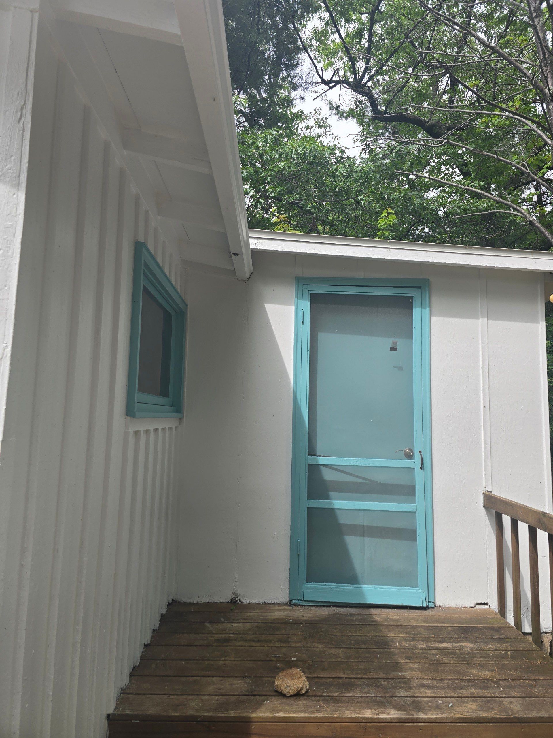 Lakeside Cottage Exterior Painting and Teal Trim Restoration in Mears by Gordon Painting