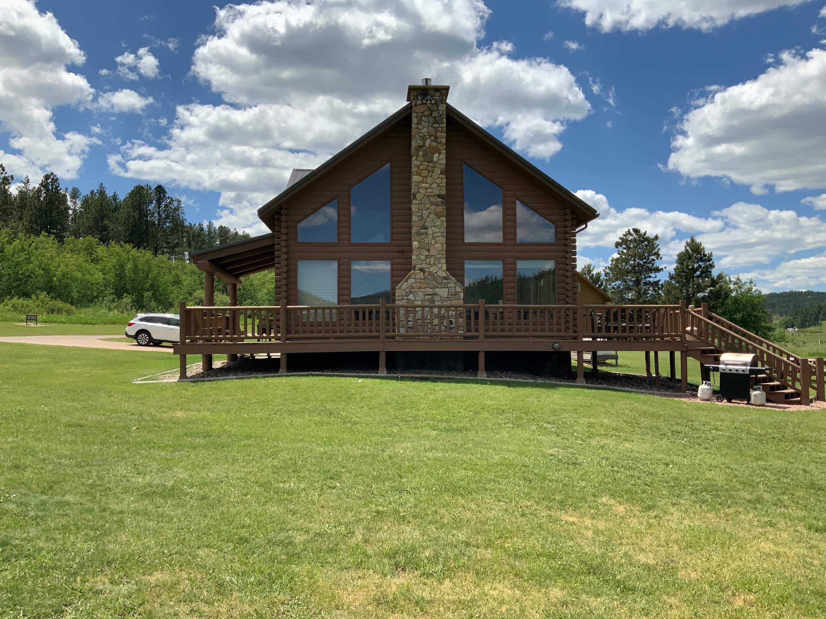 Hill Country Guest Ranch using Steel Roofing, Gutters, Log Cabin Staining by Lightning Exteriors