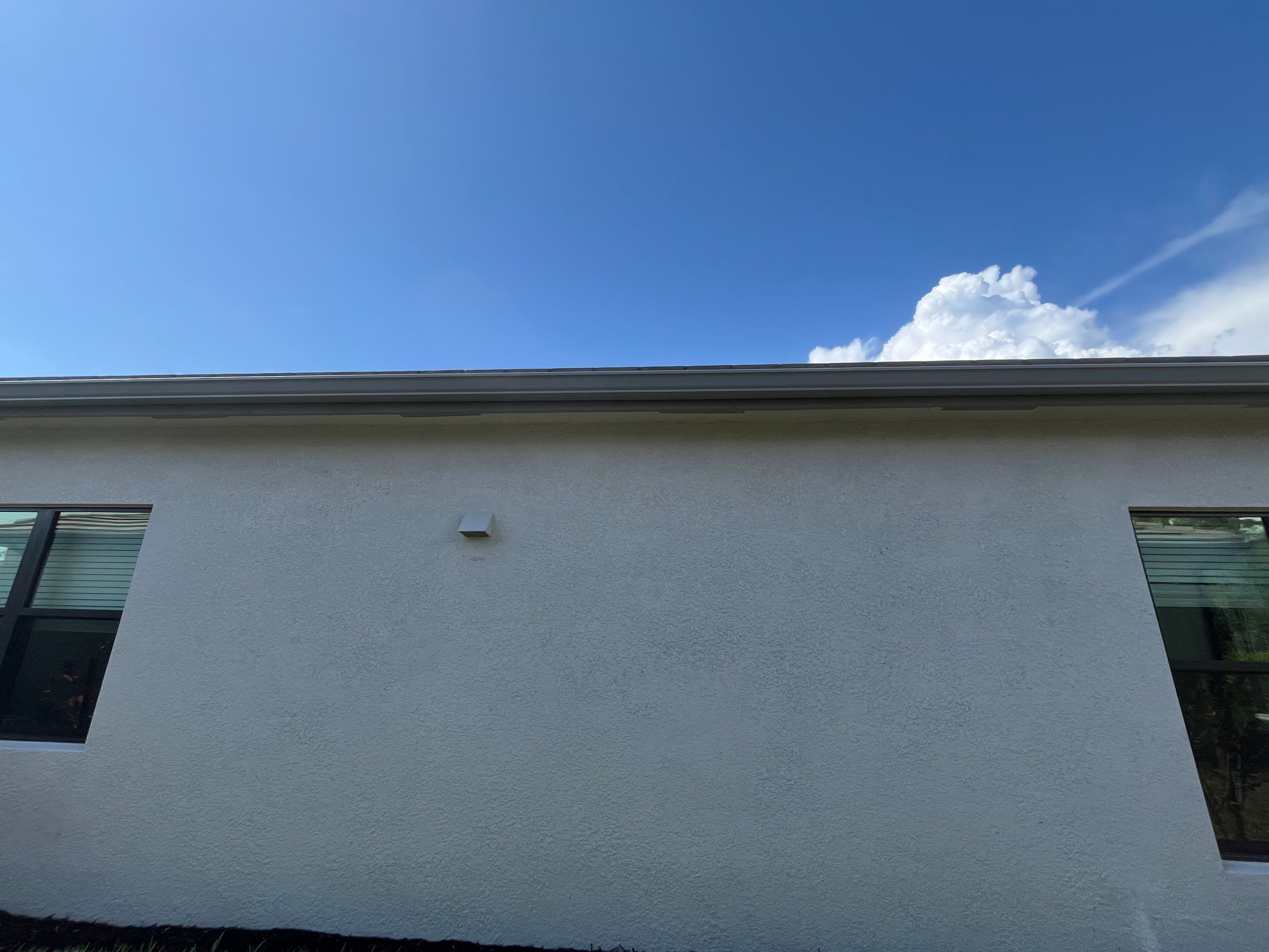 Grey Seamless Gutter Installation in Estero FL by Gutter Professors